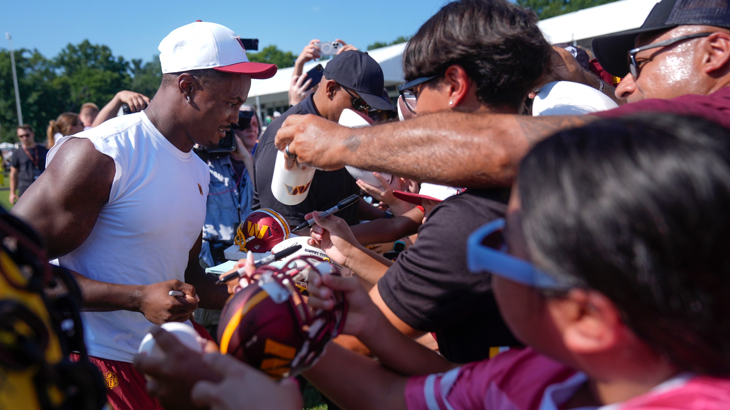 Washington Commanders wide receiver Terry McLaurin signs autographs for fans after a practice at the team's NFL football training camp, Sunday, July 27, 2025, in Ashburn, Va. (AP Photo/Mark Schiefelbein)