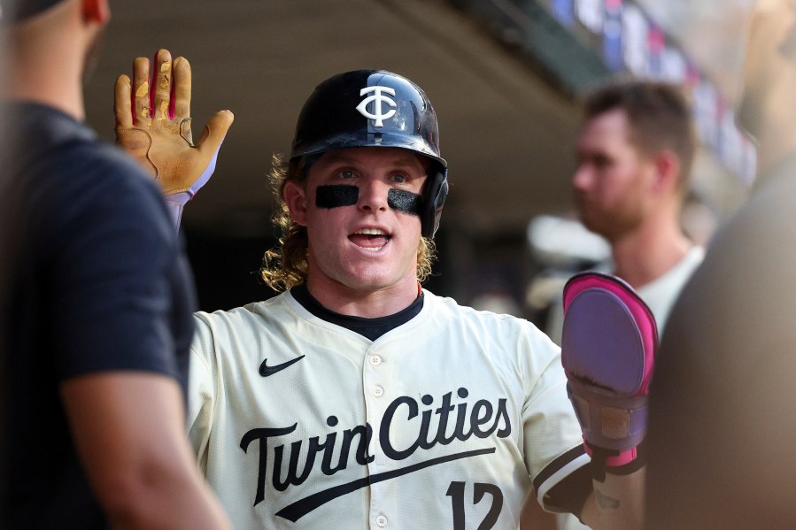 Minnesota Twins' Harrison Bader reacts after scoring on a RBI double hit by Brooks Lee during the fifth inning of baseball game against the Boston Red Sox Tuesday, July 29, 2025, in Minneapolis. (AP Photo/Matt Krohn)