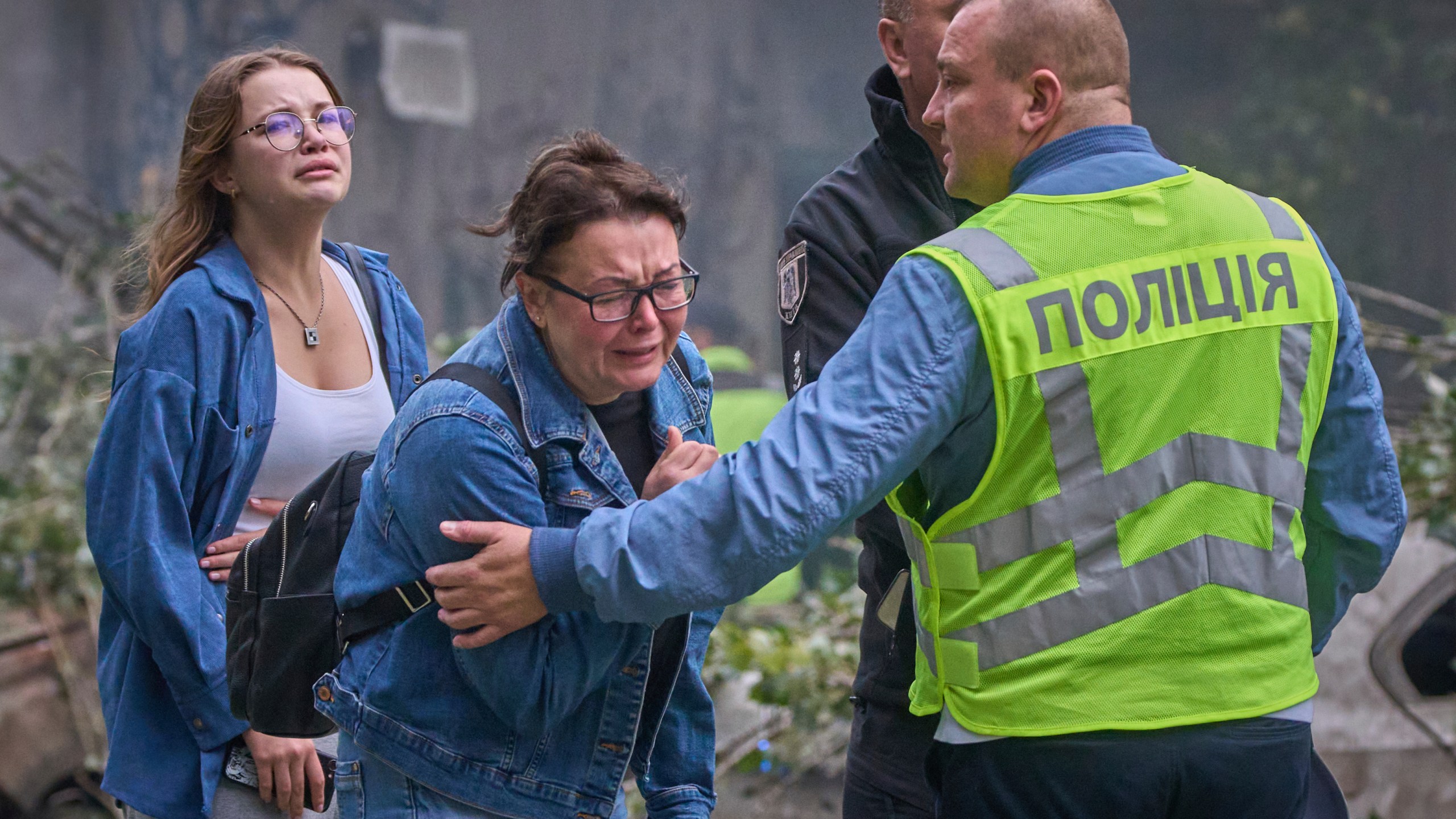 Women react outside a destroyed apartment building after a Russian missile attack in Kyiv, Ukraine, Thursday, July 31, 2025. (AP Photo/Efrem Lukatsky)