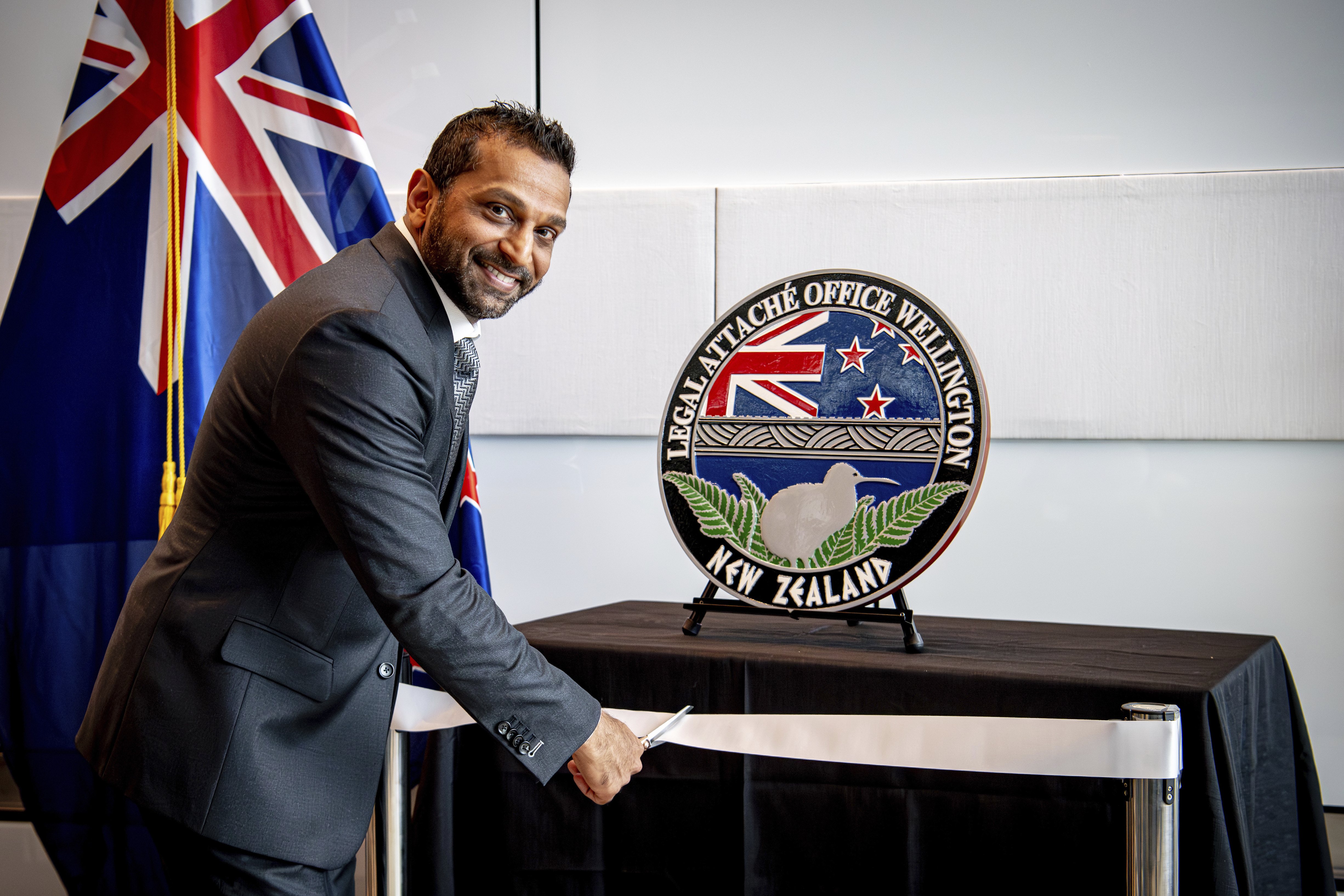 In this photo released by the US Embassy in Wellington, New Zealand, FBI Director Kash Patel cuts the ribbon at the official opening of the FBI office in Wellington, New Zealand, Thursday, July 31, 2025. (Ola Thorsen/US Embassy via AP)