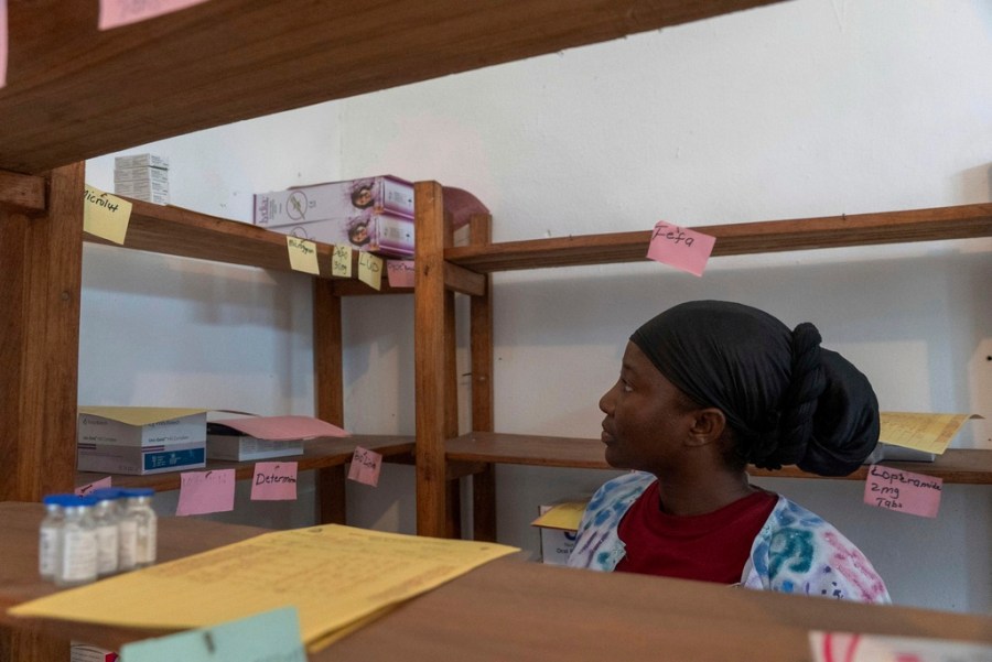 FILE - Irene A Kerkulah, the health officer in charge at the Palala Clinic, looks at an almost-empty shelf at the clinic that once held contraceptives, in Bong County, Friday, June 13, 2025. (AP Photo/Annie Risemberg, File)