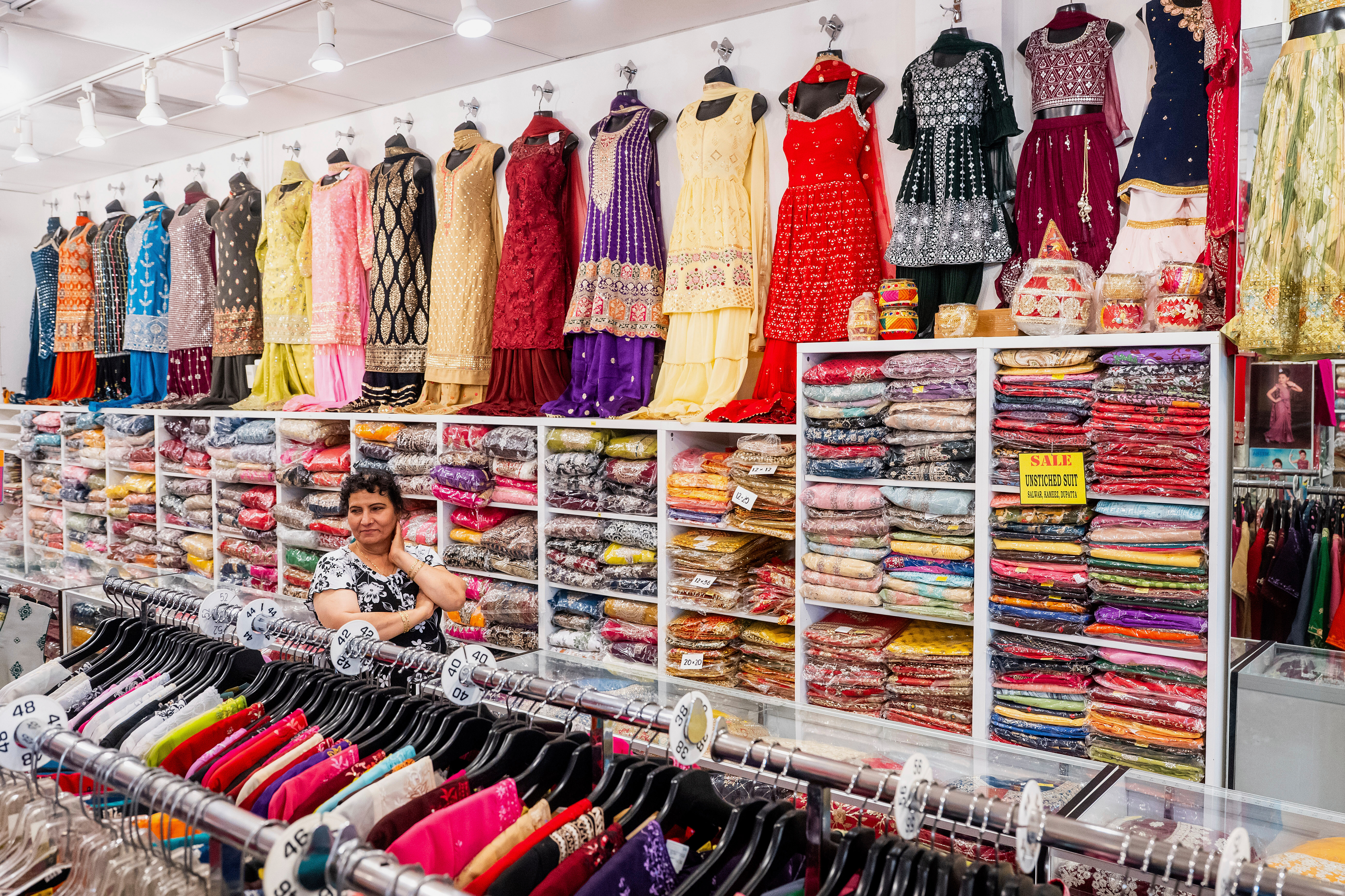 A worker waits for customers at Roopam Sarees, which sells clothing imported from India, on Thursday, July 31, 2025, in Berkeley, Calif. (AP Photo/Noah Berger)