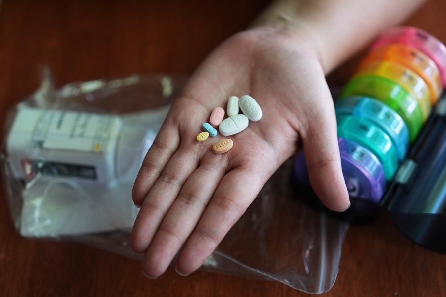 Amanda Schlesier holds her prescription medication, including a chemotherapy pill, Calquence, foreground, in Farmington Hills, Mich., Wednesday, July 23, 2025. (AP Photo/Paul Sancya)