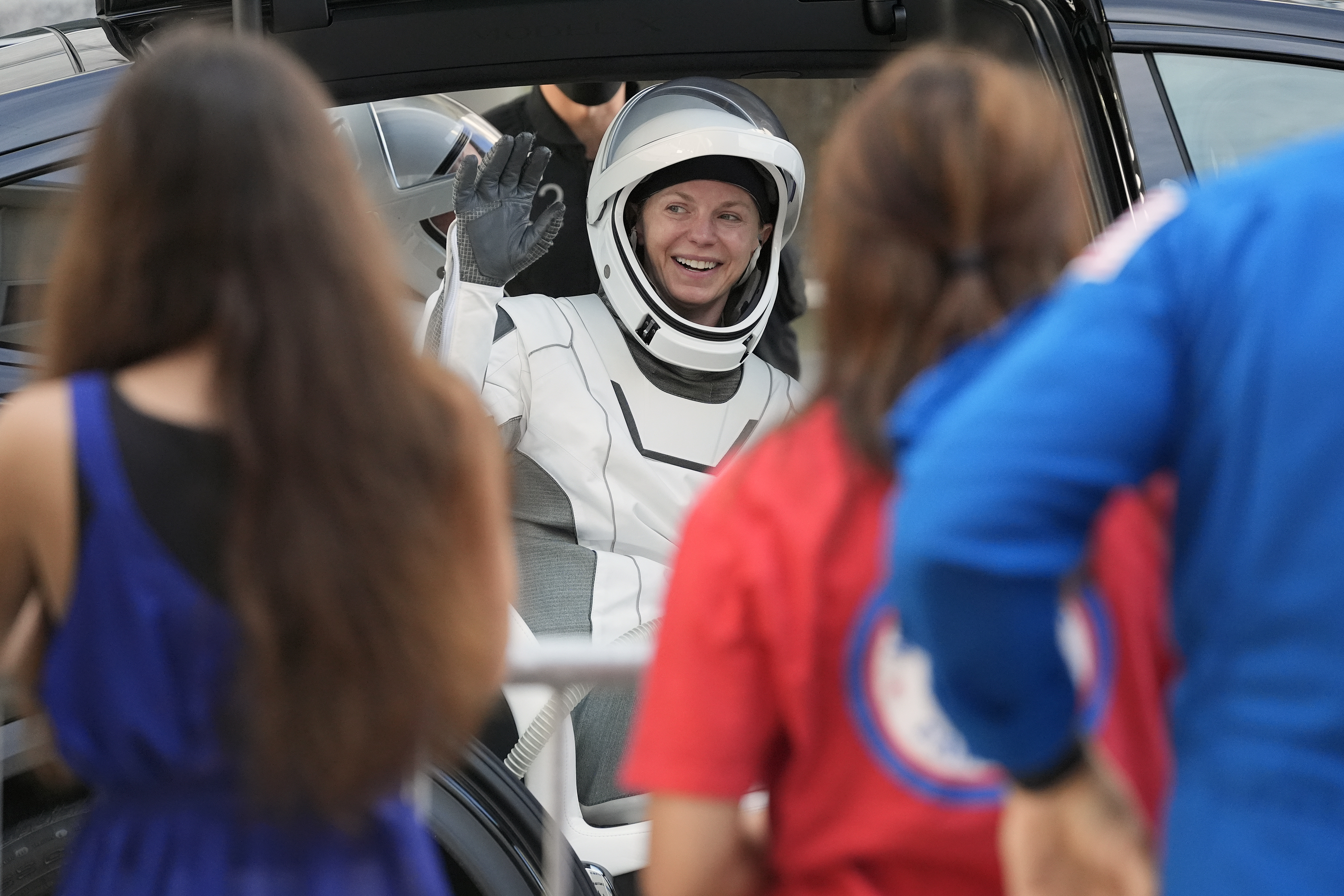 Astronaut Zena Cardman waves as she leaves the Operations and Checkout Building for a trip the Kennedy Space Center's Launch Pad 39-A and a planned liftoff on a SpaceX Falcon 9 rocket Friday, Aug. 1, 2025, in Cape Canaveral , Fla. (AP Photo/John Raoux)