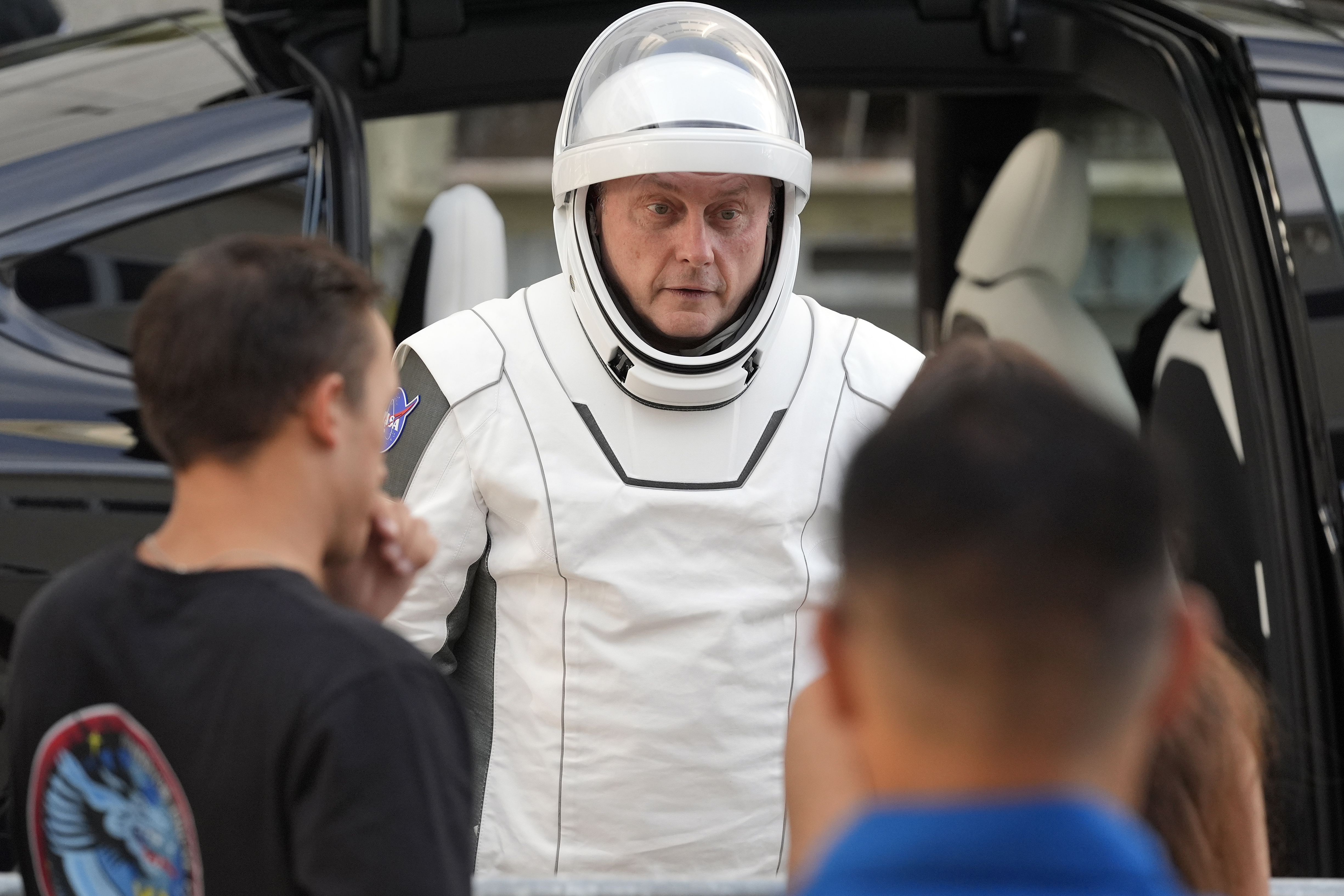 Astronaut Mike Fincke speaks to friends as he leaves the Operations and Checkout Building for a trip the Kennedy Space Center's Launch Pad 39-A and a planned liftoff on a SpaceX Falcon 9 rocket Friday, Aug. 1, 2025, in Cape Canaveral , Fla. (AP Photo/John Raoux)