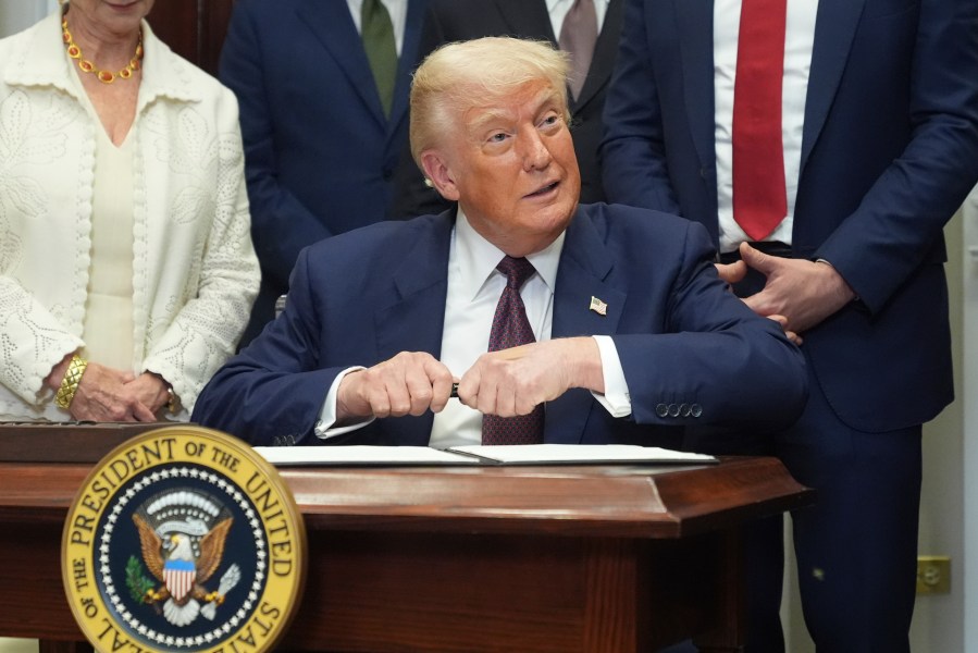 President Donald Trump signs an executive order restarting the Presidential Fitness Test in public schools, Thursday, July 31, 2025, in the Roosevelt Room of the White House in Washington. (AP Photo/Jacquelyn Martin)