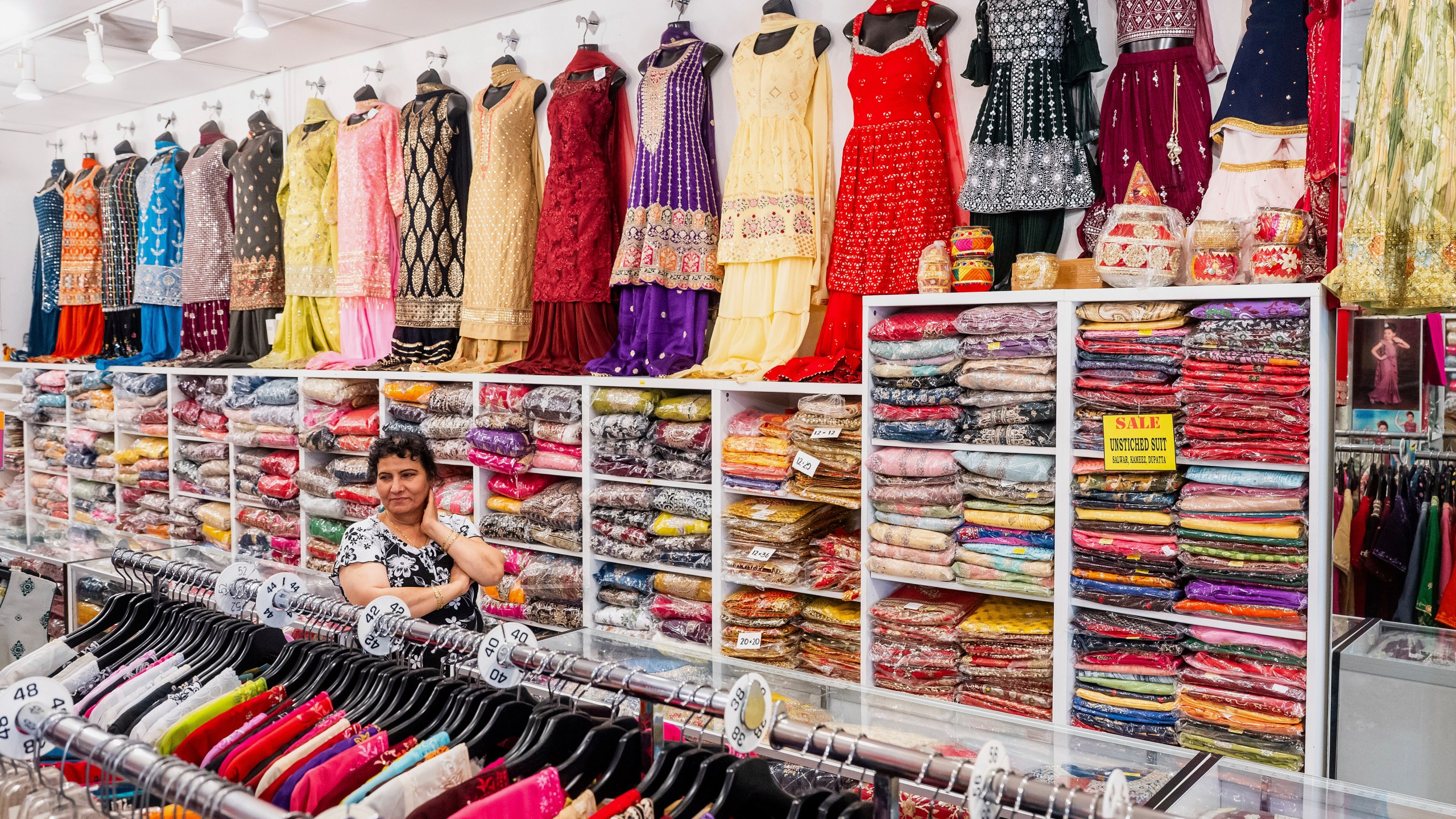 A worker waits for customers at Roopam Sarees, which sells clothing imported from India, on Thursday, July 31, 2025, in Berkeley, Calif. (AP Photo/Noah Berger)