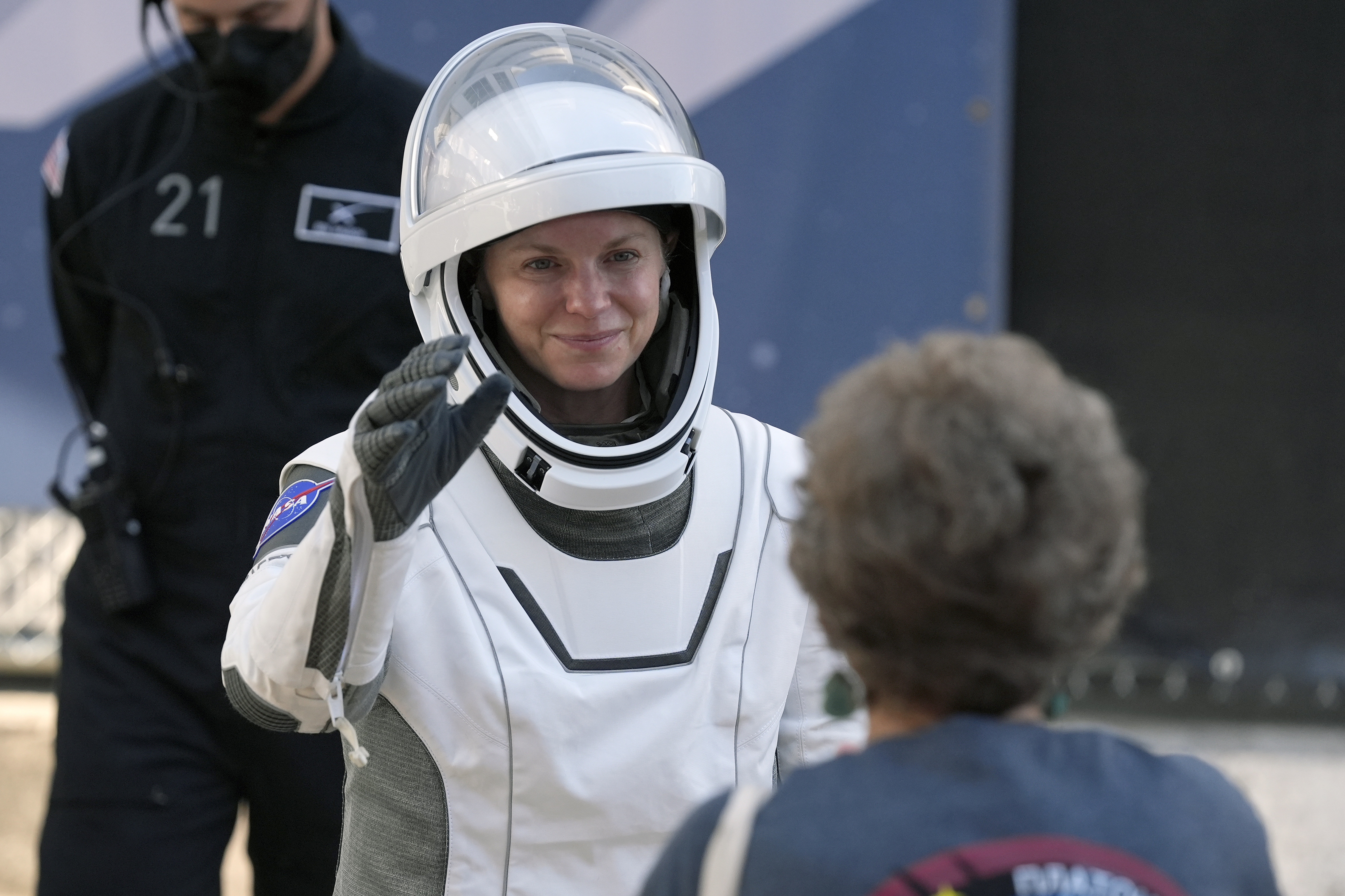 Astronaut Zena Cardman waves as she leaves the Operations and Checkout Building for a trip the Kennedy Space Center's Launch Pad 39-A and a planned liftoff on a SpaceX Falcon 9 rocket Friday, Aug. 1, 2025, in Cape Canaveral , Fla. (AP Photo/John Raoux)