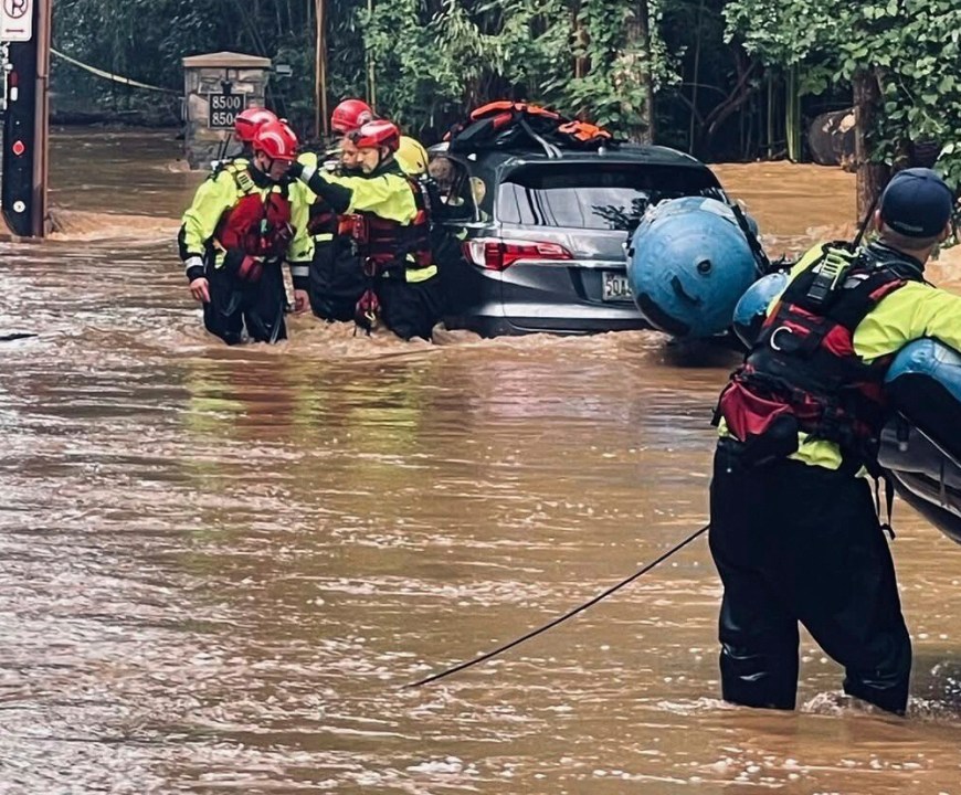 This photo provided by MontgomeryCo Fire shows the rescue of an 8-year old after flash flooding on Thursday, July 31, 2025. in Montgomery County, Md. (MontgomeryCo Fire via AP)