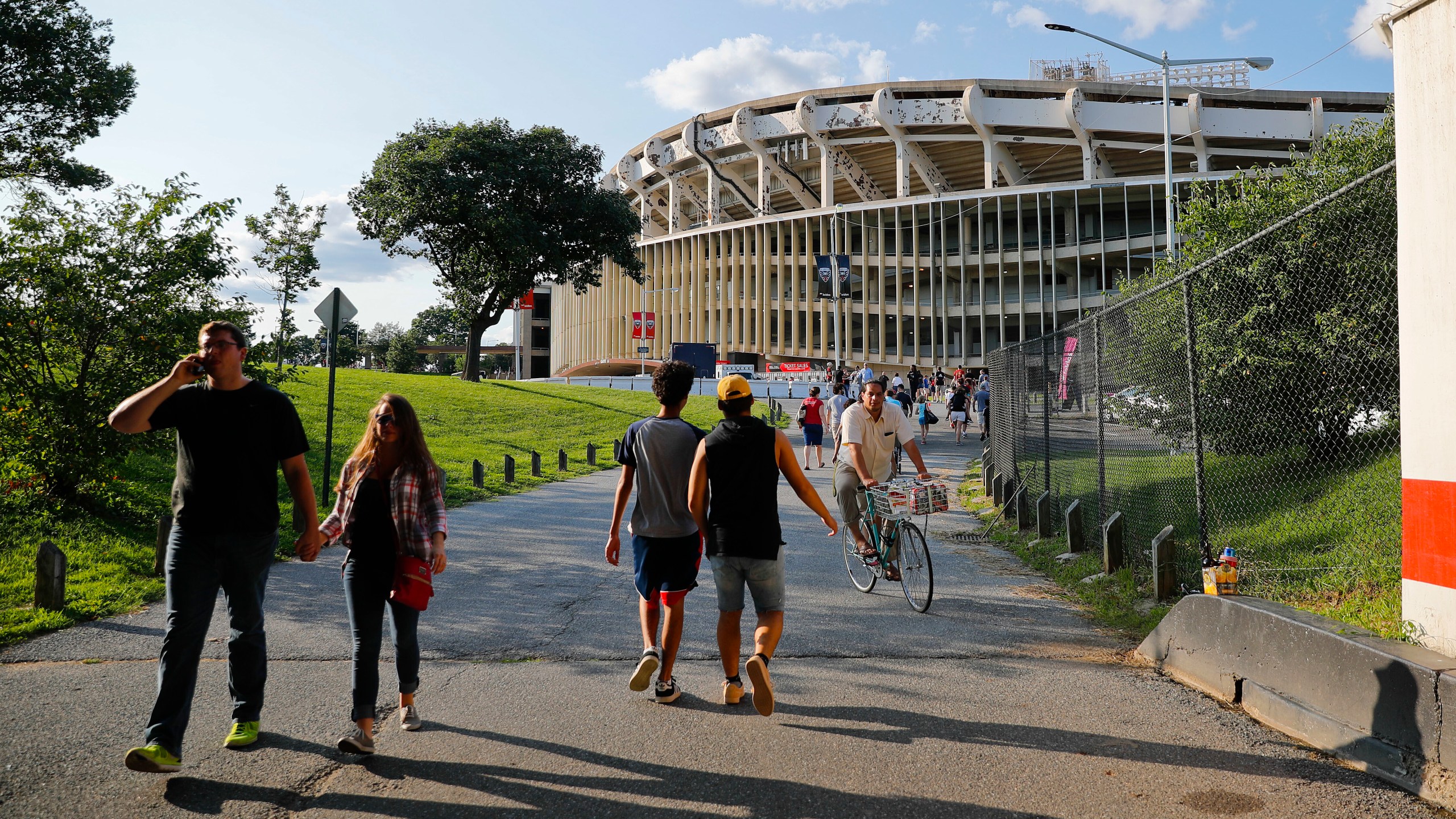 FILE - People make their way to RFK Stadium in Washington before the start of an MLS soccer match between D.C. United and Toronto FC, Saturday, Aug. 5, 2017. D.C. (AP Photo/Pablo Martinez Monsivais, File)