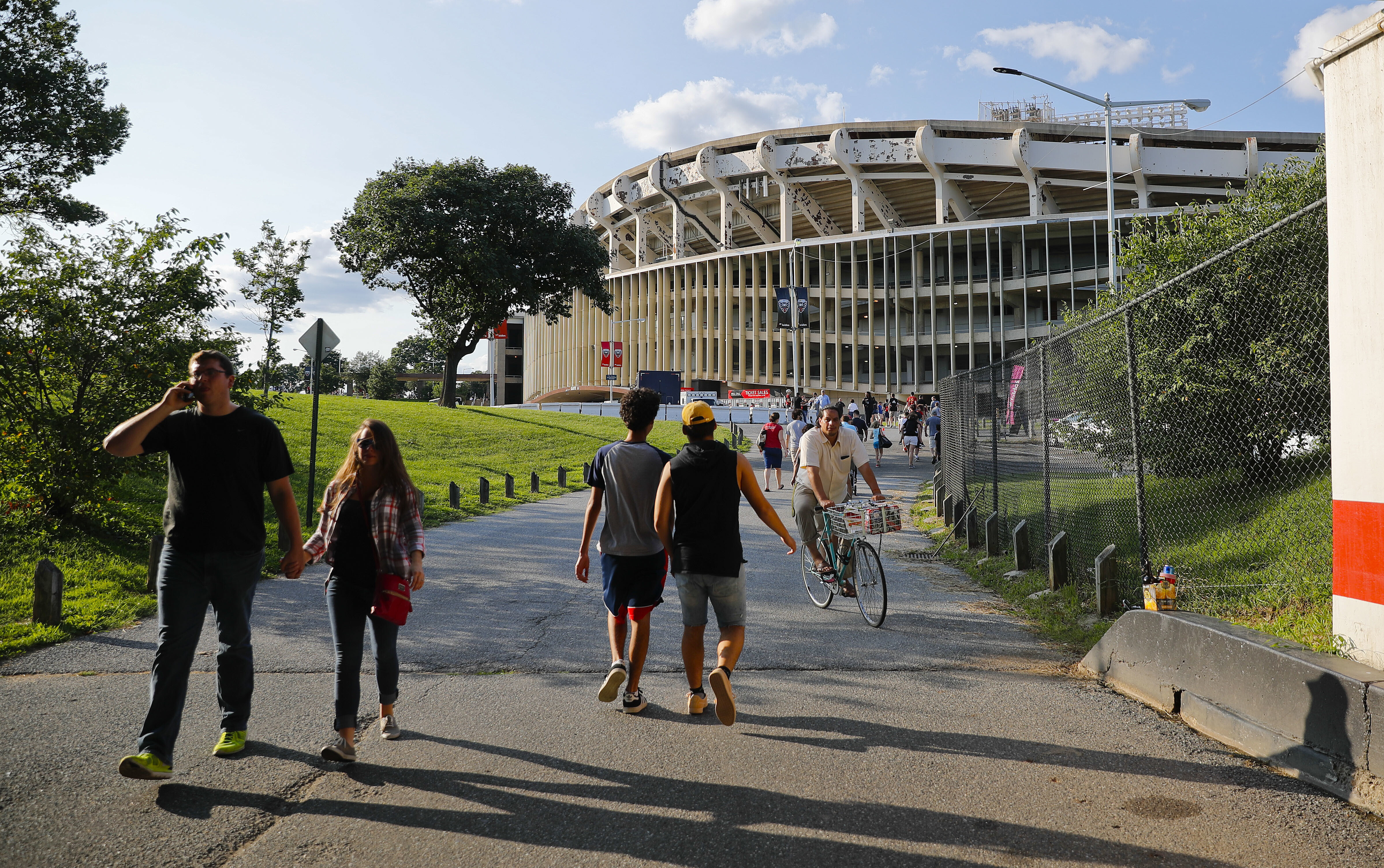 FILE - People make their way to RFK Stadium in Washington before the start of an MLS soccer match between D.C. United and Toronto FC, Saturday, Aug. 5, 2017. D.C. (AP Photo/Pablo Martinez Monsivais, File)