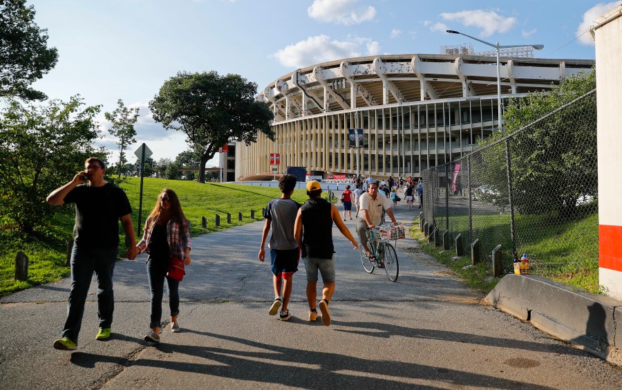 FILE - People make their way to RFK Stadium in Washington before the start of an MLS soccer match between D.C. United and Toronto FC, Saturday, Aug. 5, 2017. D.C. (AP Photo/Pablo Martinez Monsivais, File)