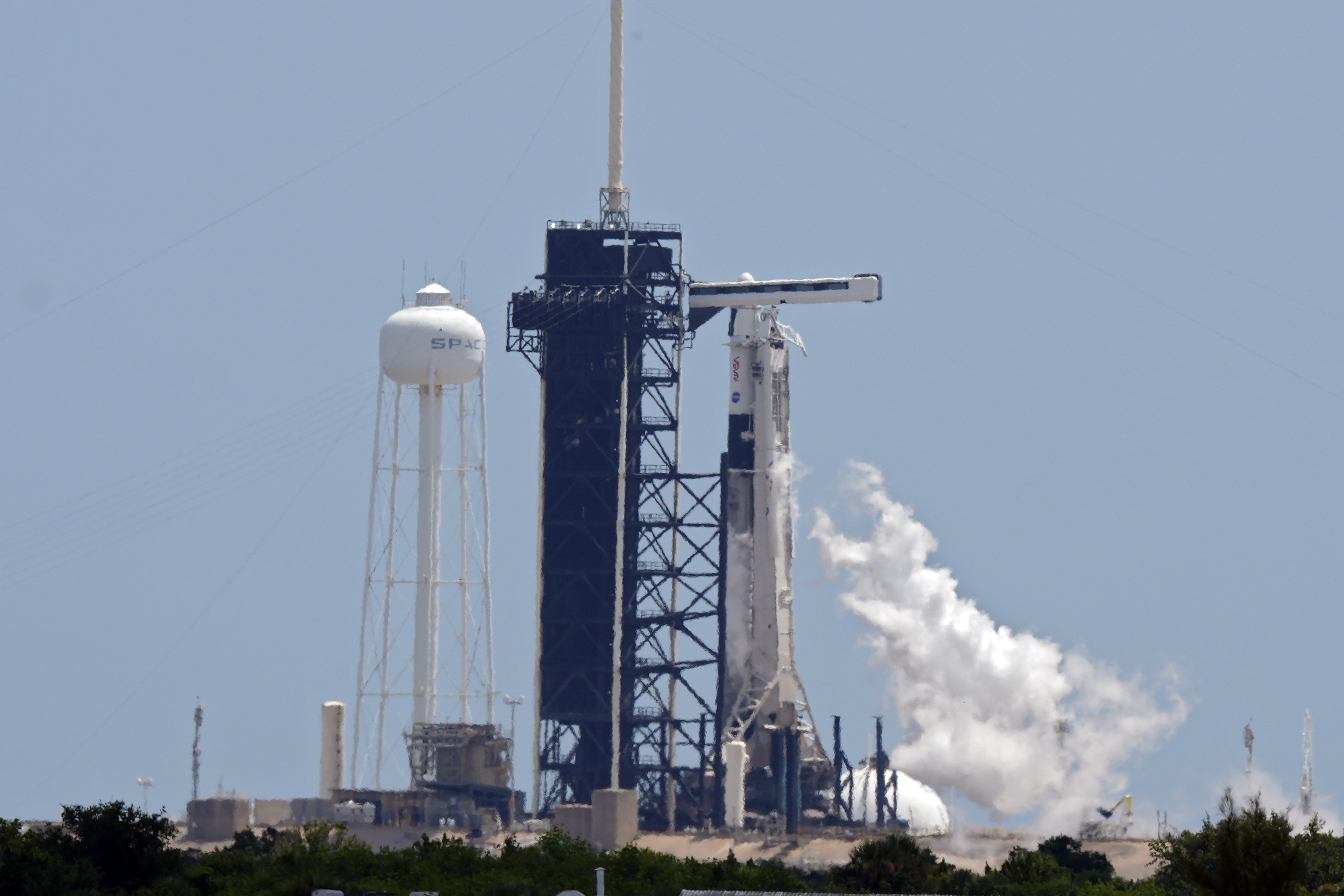 FILE - A SpaceX Falcon 9 rocket, with the crew Dragon capsule attached, vents fuel while sitting on Kennedy Space Center's Launch Pad 39-A, July 31, 2025, in Cape Canaveral, Fla. (AP Photo/Chris O'Meara, File)