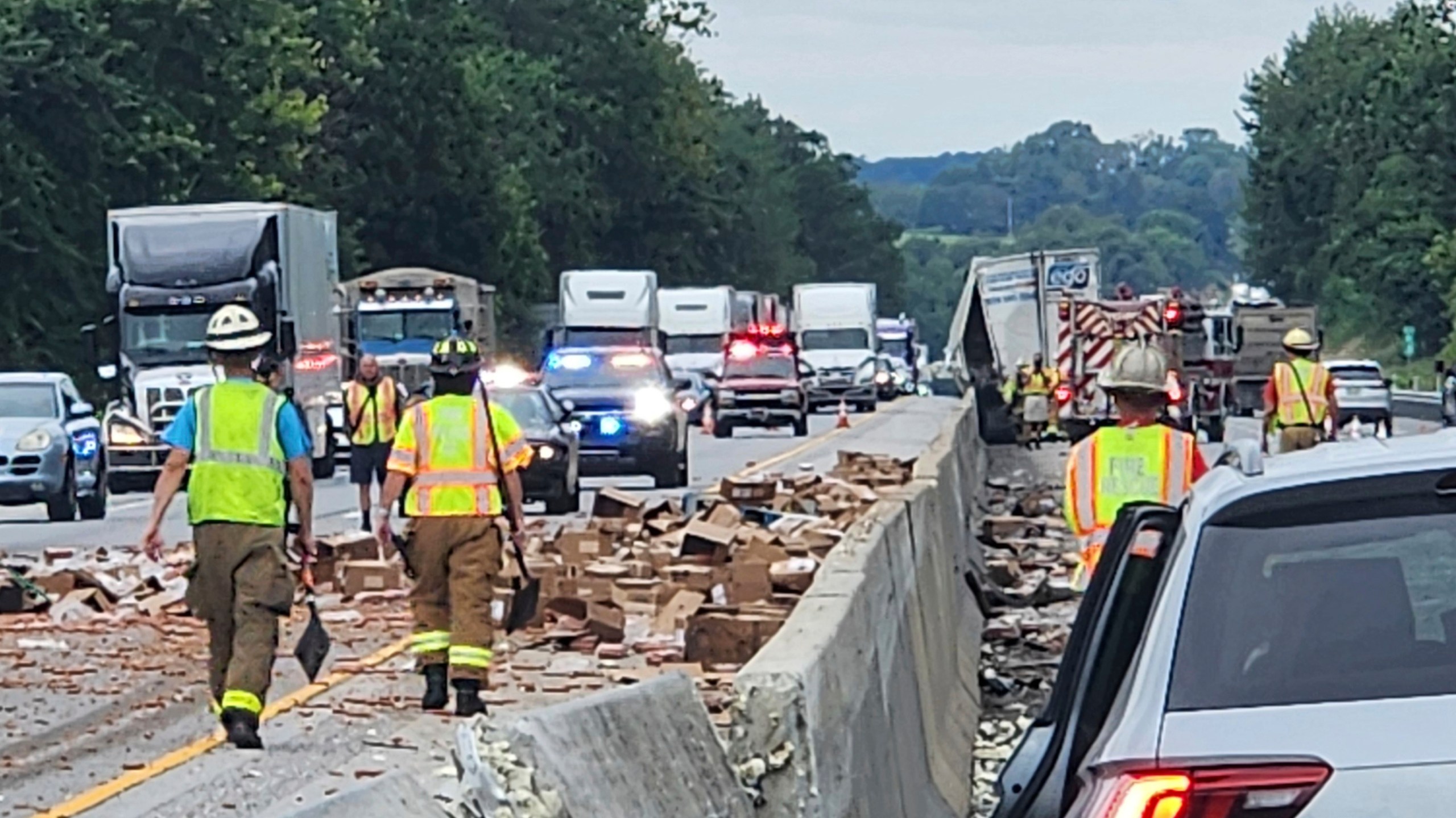 Rescue crews clean up a truckload of hot dogs that spilled out of a tractor-trailer on Friday, August 1, 2025, along Interstate 83 in Shrewsbury, Pa. (Shrewsbury Volunteer Fire Company via AP)