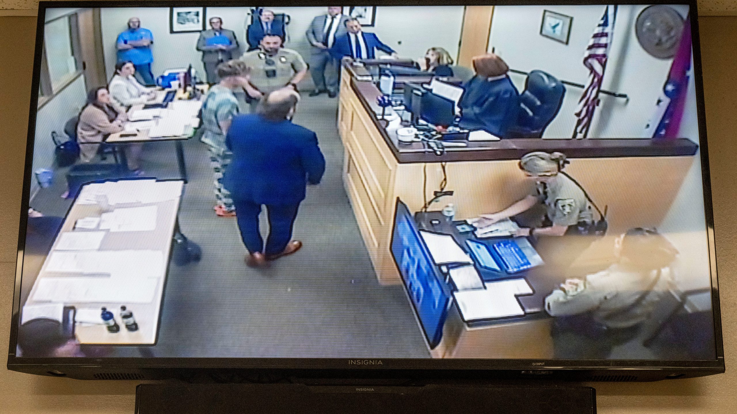 Andrew James McGann, charged with two counts of capital murder, is seen on the video monitor as he appears in front of District Judge Terra Stephenson for his bond hearing at the Washington County Detention Center. Friday, Aug, 1, 2025, in Fayetteville, Ark. (AP Photo/Michael Woods)