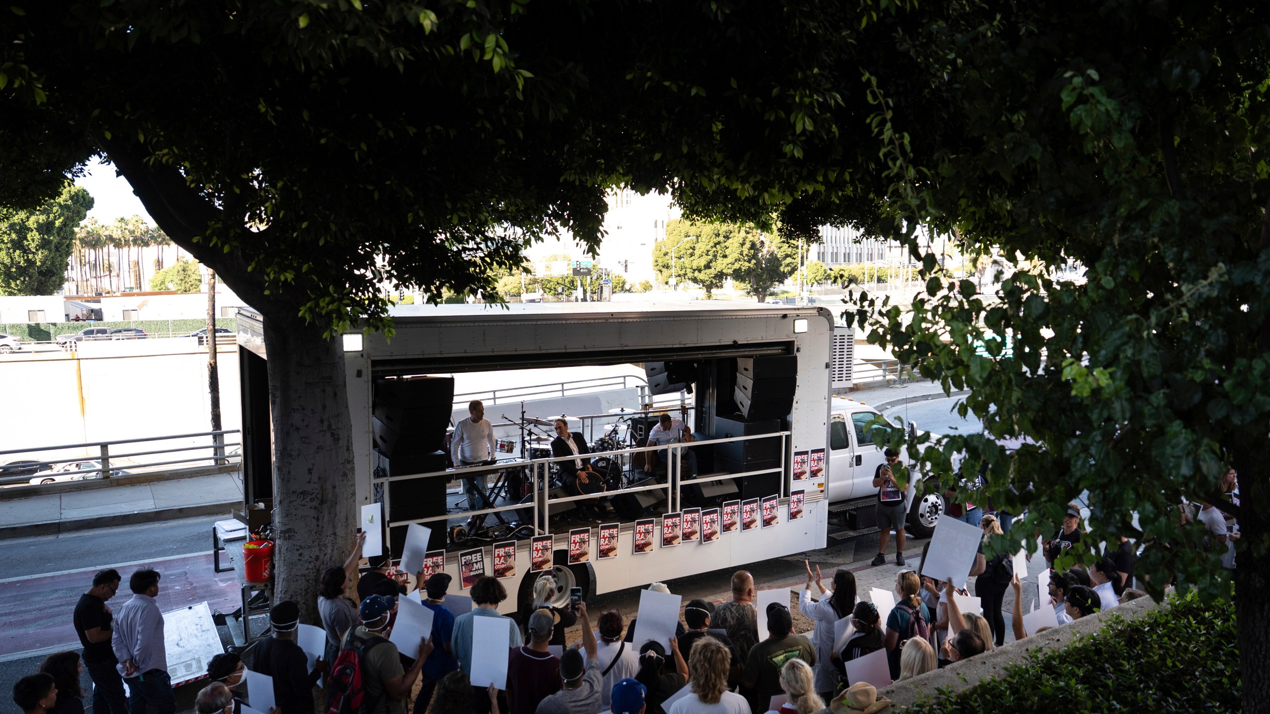 Fellow musicians of Rami Othmane, a Tunisian man detained at the U.S. Immigration and Customs Enforcement facility, perform during a rally outside the facility in Los Angeles Friday, July 25, 2025. (AP Photo/Jae C. Hong)