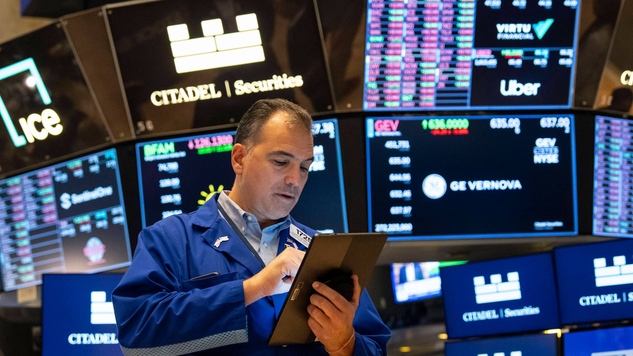 A Trader works on the floor of the New York Stock Exchange, Friday, Aug. 1, 2025, in New York. (AP Photo/Yuki Iwamura)