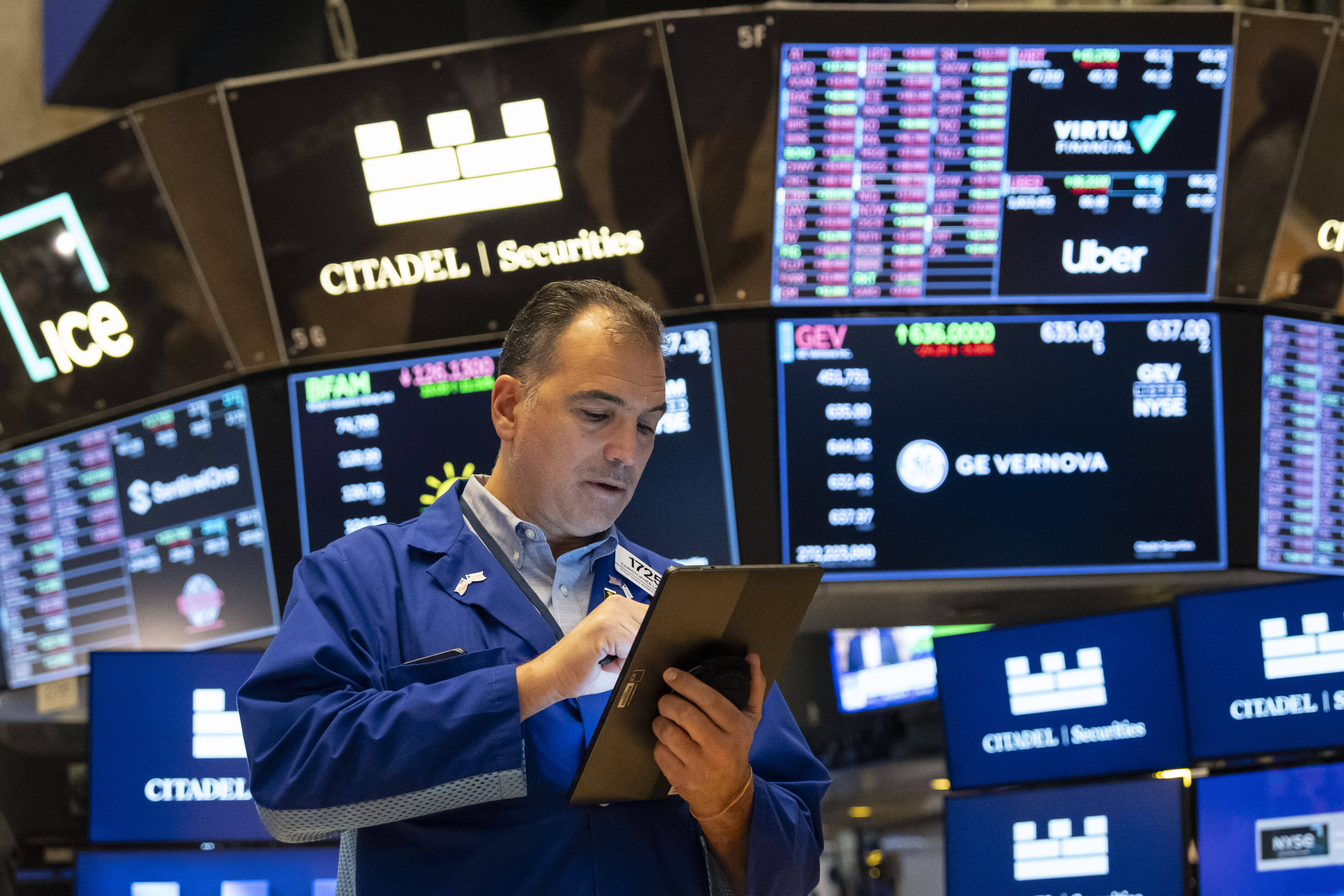 A Trader works on the floor of the New York Stock Exchange, Friday, Aug. 1, 2025, in New York. (AP Photo/Yuki Iwamura)