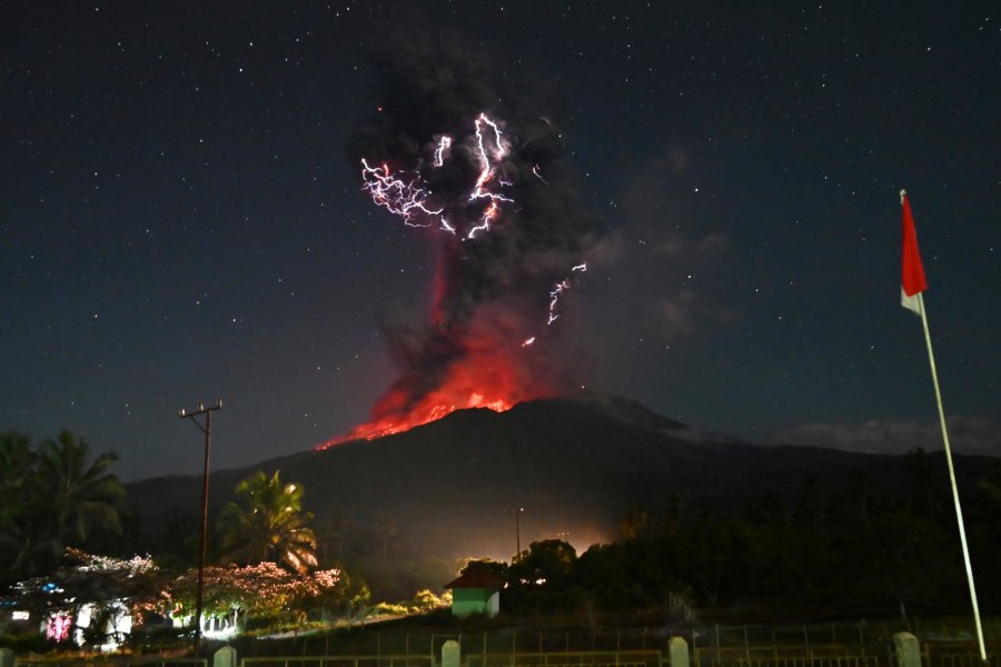 In this photo released by Geological Agency (Badan Geologi) of the Indonesia's Ministry of Energy and Mineral Resources, lightning strikes as Mount Lewotobi Laki-Laki spews volcanic material during an eruption in East Flores, Indonesia, Friday, August. 1, 2025. (Badan Geologi via AP)
