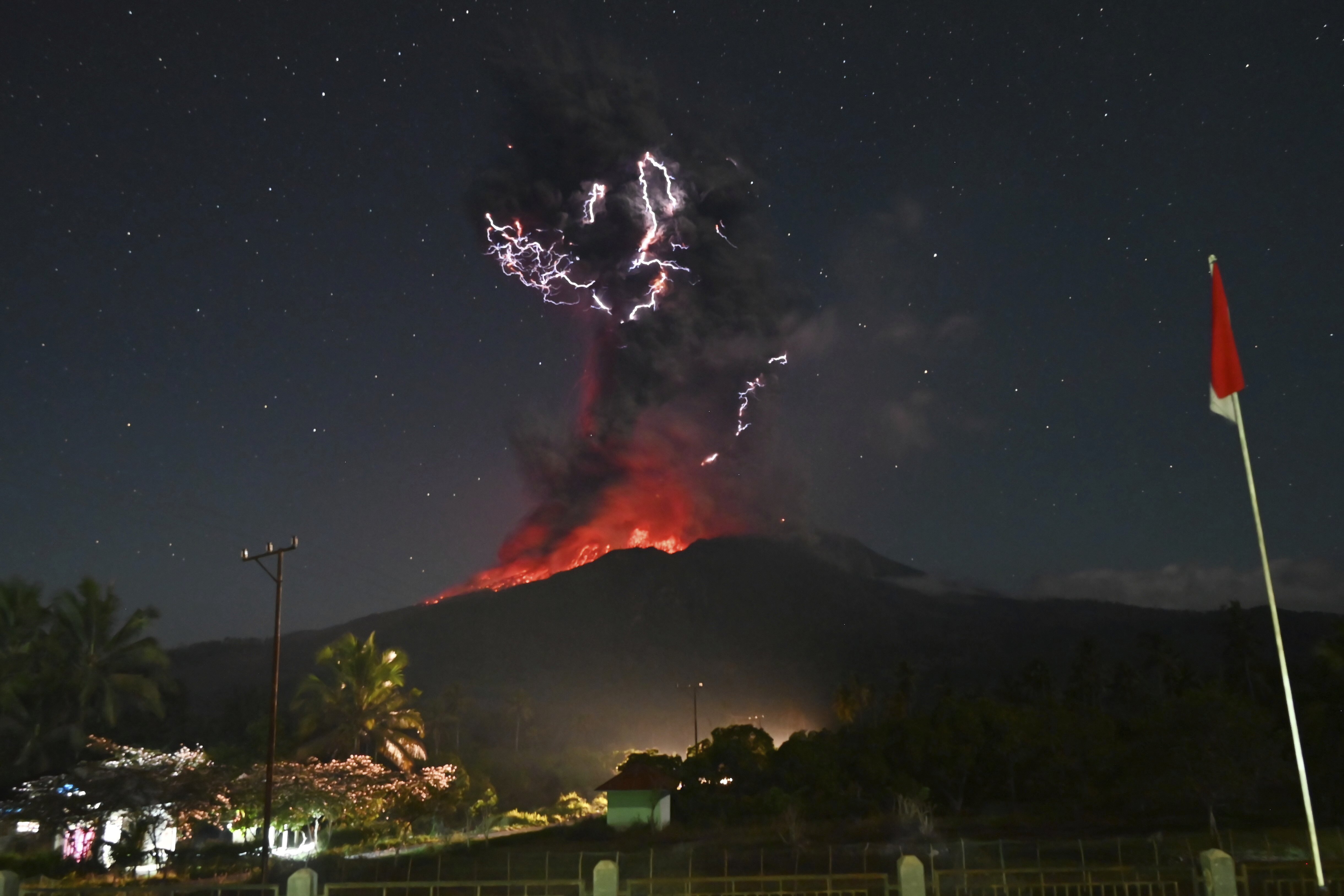 In this photo released by Geological Agency (Badan Geologi) of the Indonesia's Ministry of Energy and Mineral Resources, lightning strikes as Mount Lewotobi Laki-Laki spews volcanic material during an eruption in East Flores, Indonesia, Friday, August. 1, 2025. (Badan Geologi via AP)