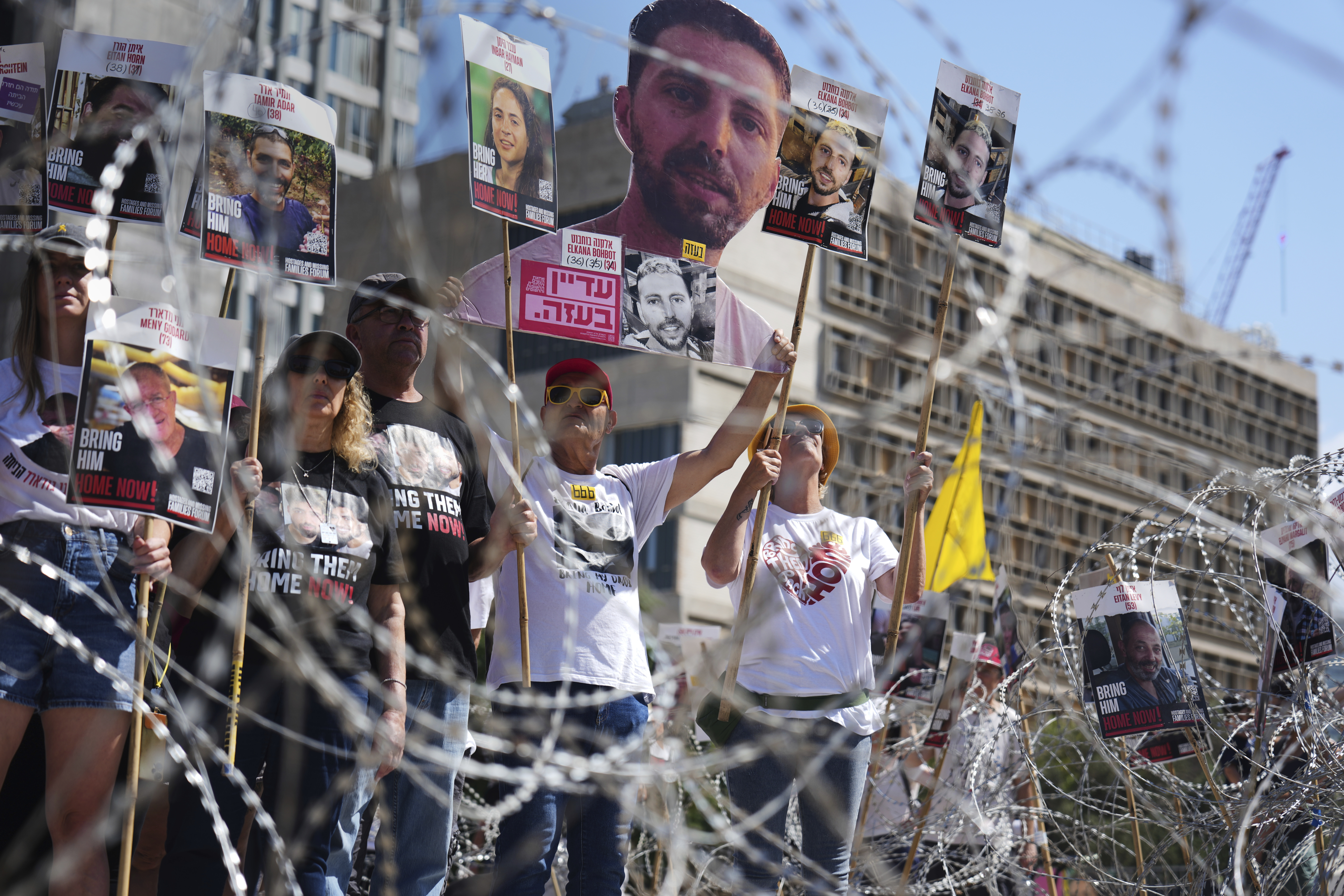 Families of hostages protest, demanding the release from Hamas captivity in the Gaza Strip, at the plaza known as the hostages square in Tel Aviv, Israel, Saturday, Aug. 2, 2025. (AP Photo/Ariel Schalit)