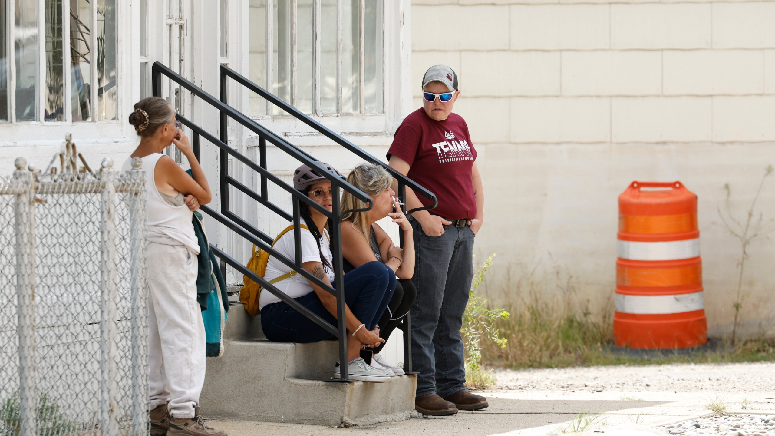 People are seen in the town of Anaconda, Mont., following a reported shooting, Friday, Aug. 1, 2025. (Joseph Scheller/The Montana Standard via AP)