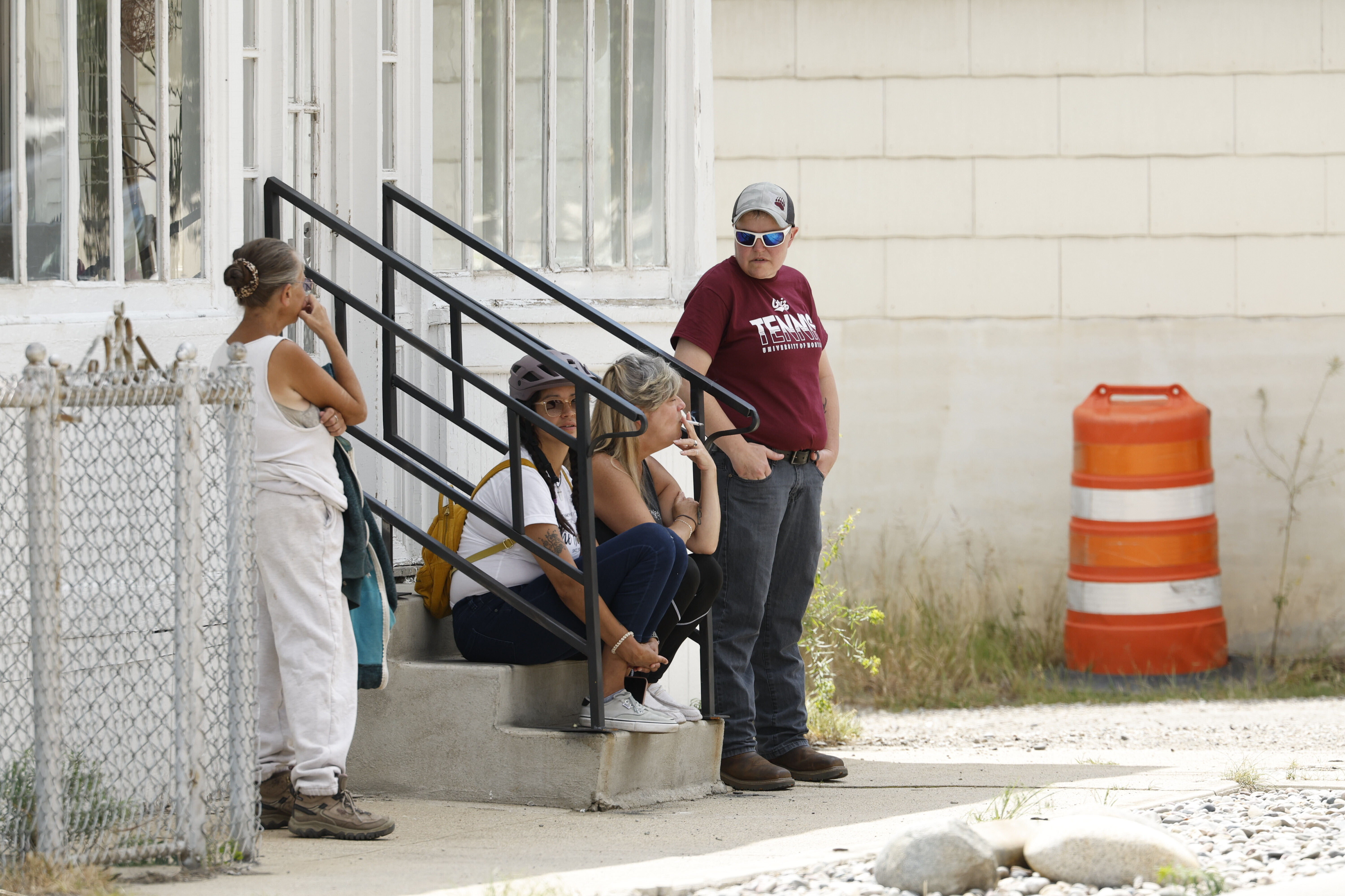 People are seen in the town of Anaconda, Mont., following a reported shooting, Friday, Aug. 1, 2025. (Joseph Scheller/The Montana Standard via AP)