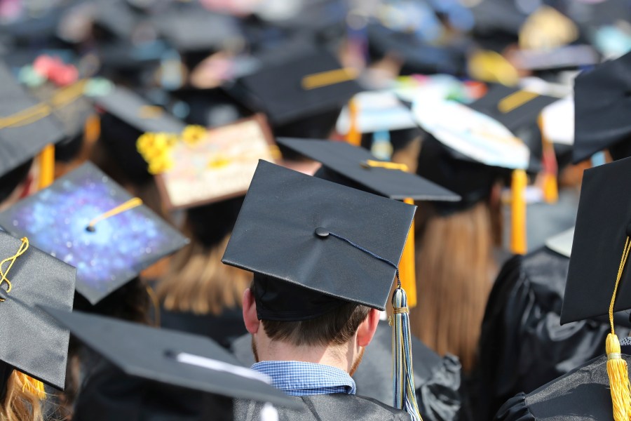 FILE - In this May 5, 2018, file photo, graduates at the University of Toledo commencement ceremony in Toledo, Ohio. (AP Photo/Carlos Osorio, File)