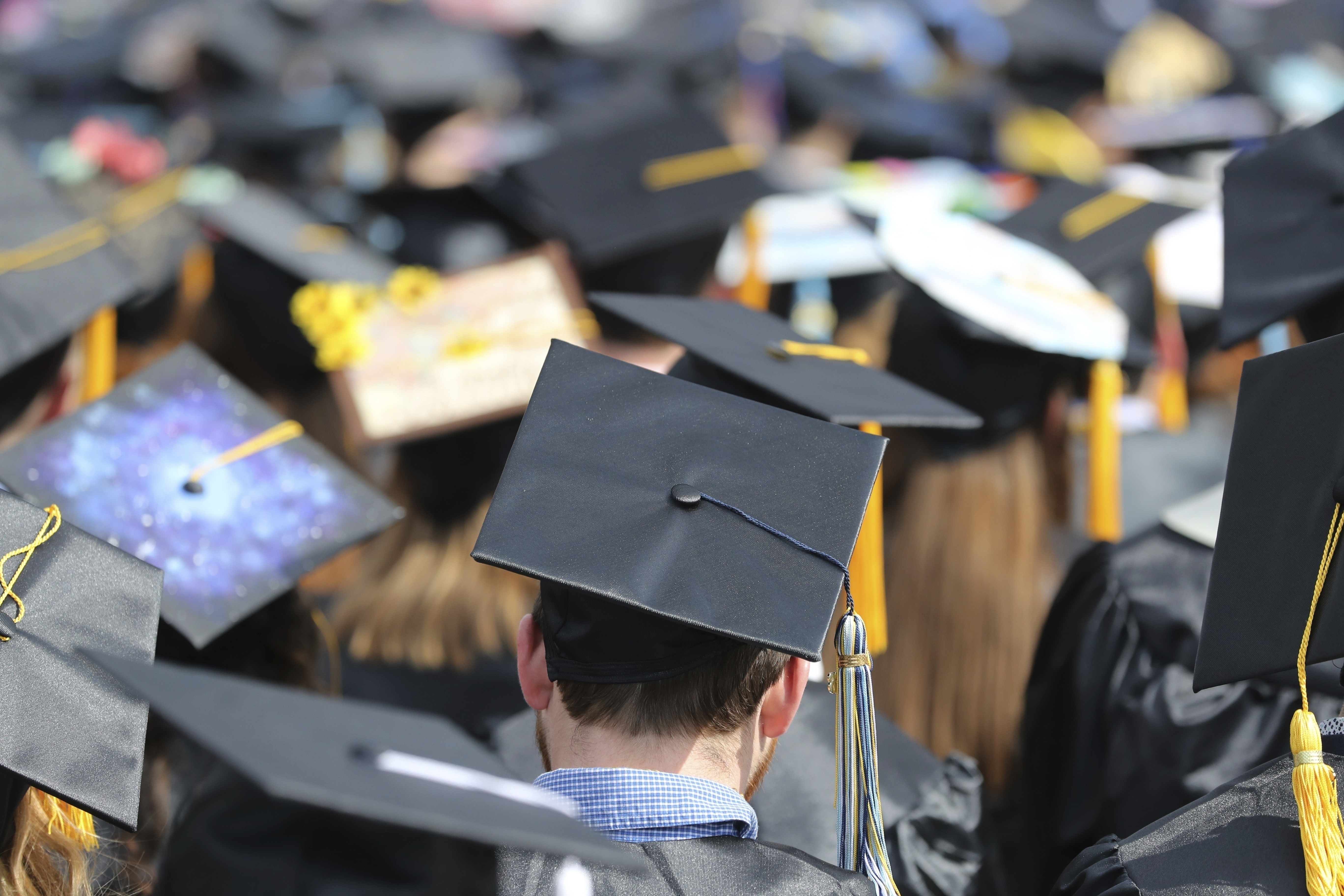 FILE - In this May 5, 2018, file photo, graduates at the University of Toledo commencement ceremony in Toledo, Ohio. (AP Photo/Carlos Osorio, File)