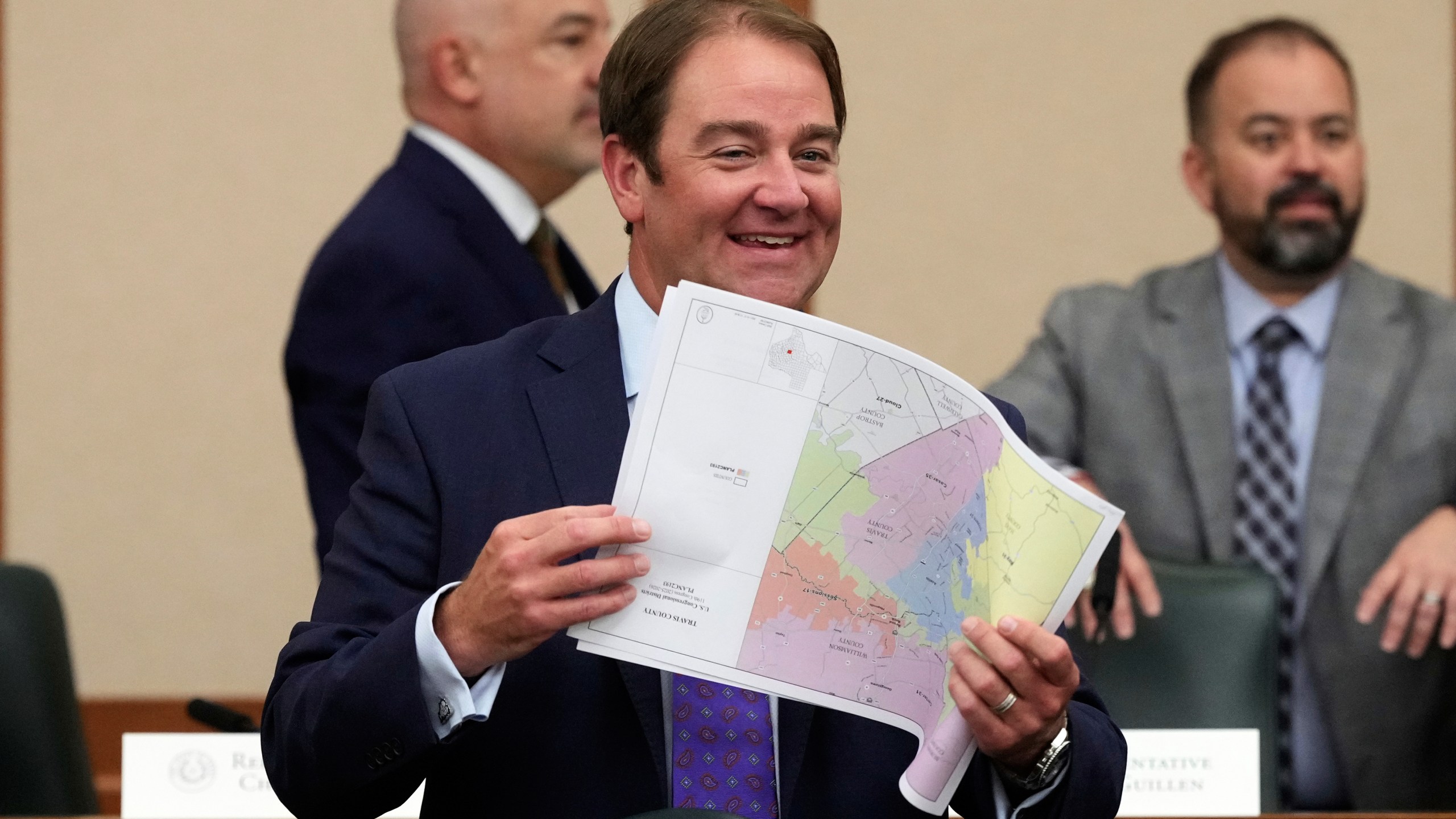 Texas state Rep. John McQueeney, R-Fort Worth, looks through U.S. Congressional District maps during a redistricting hearing at the Texas Capitol, Thursday, July 24, 2025, in Austin, Texas. (AP Photo/Eric Gay)