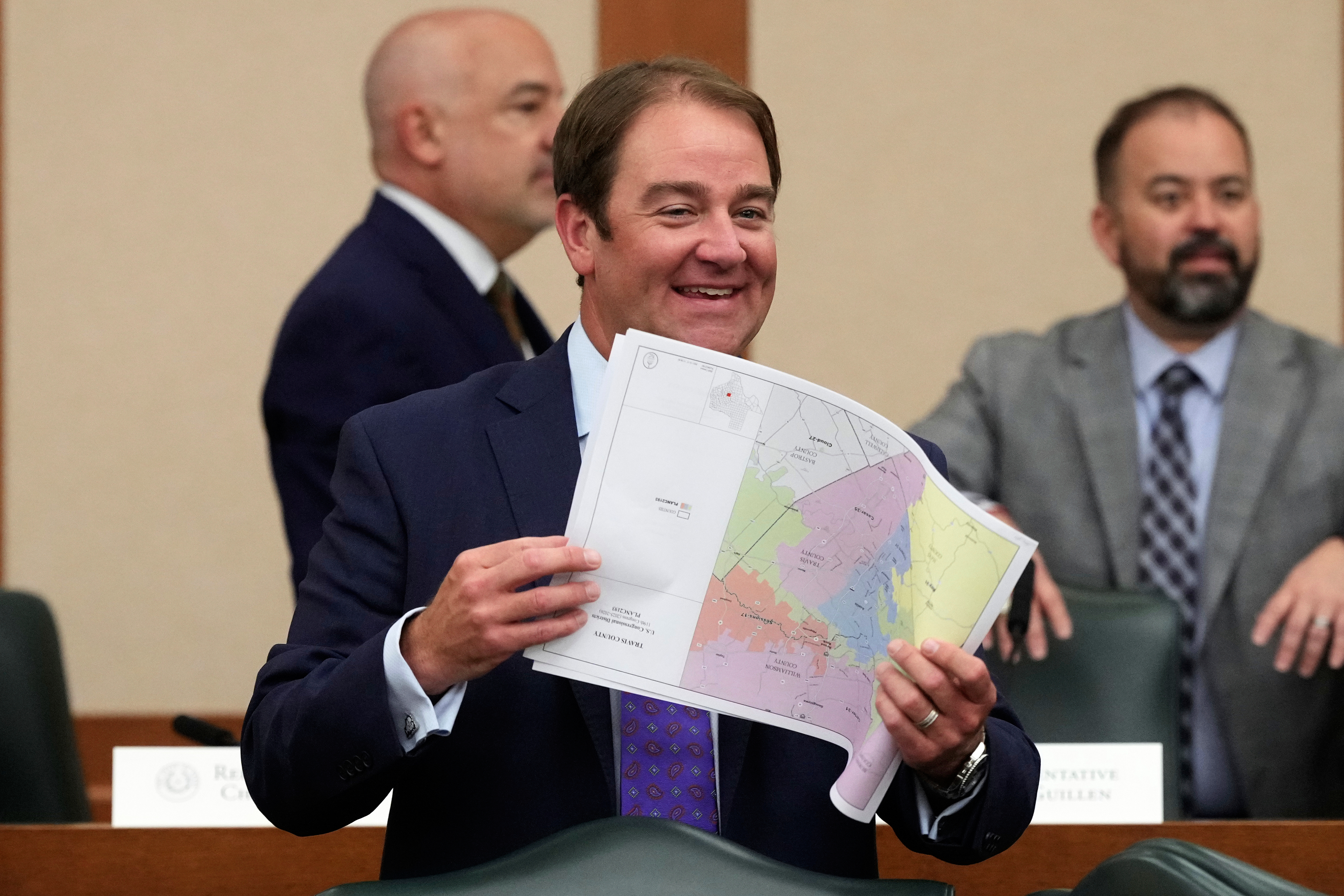 Texas state Rep. John McQueeney, R-Fort Worth, looks through U.S. Congressional District maps during a redistricting hearing at the Texas Capitol, Thursday, July 24, 2025, in Austin, Texas. (AP Photo/Eric Gay)