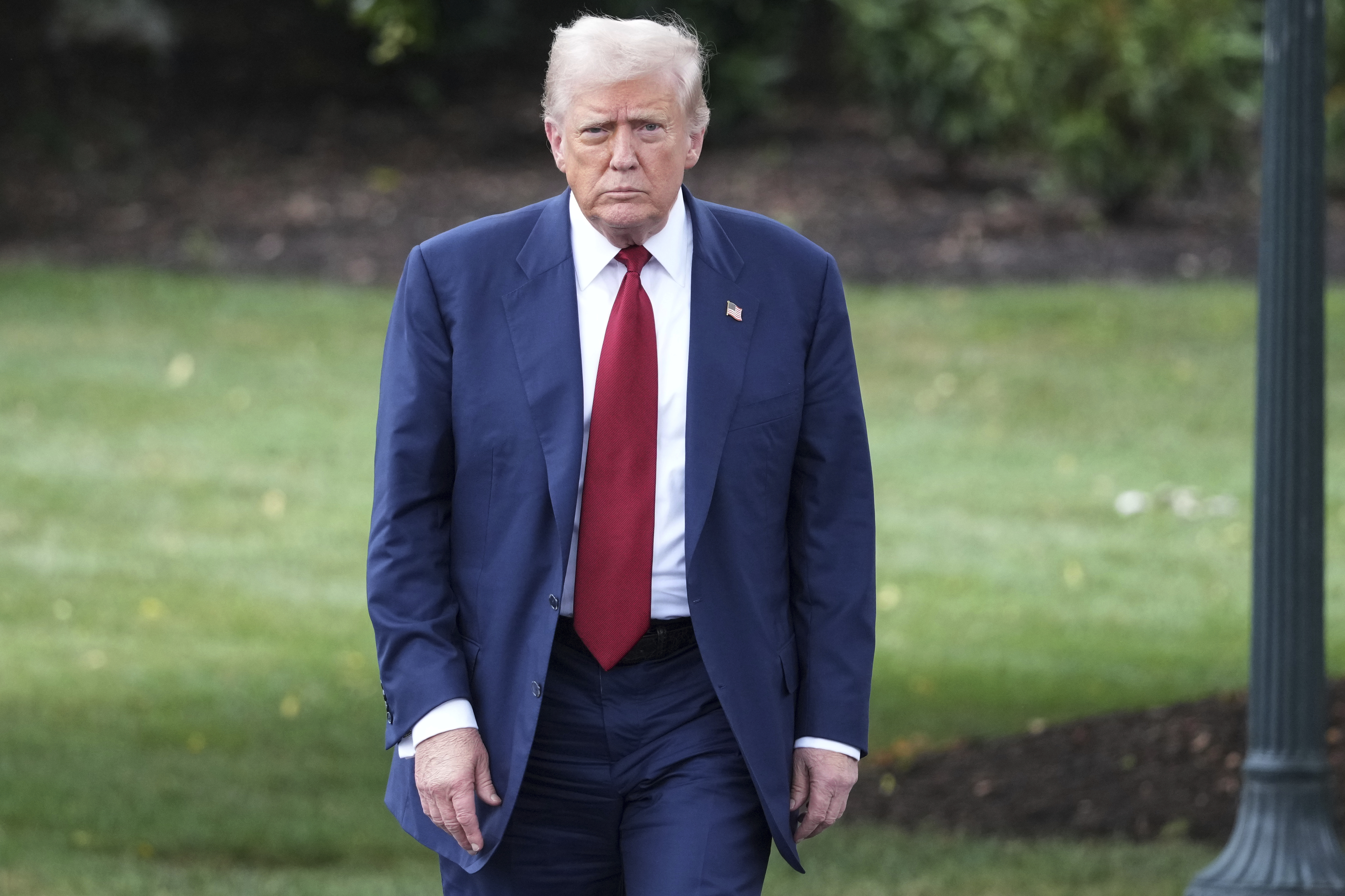 President Donald Trump walks across the South Lawn of the White House to board Marine One en route to Joint Base Andrews, Md., Friday, Aug. 1, 2025, in Washington. (AP Photo/Jacquelyn Martin)