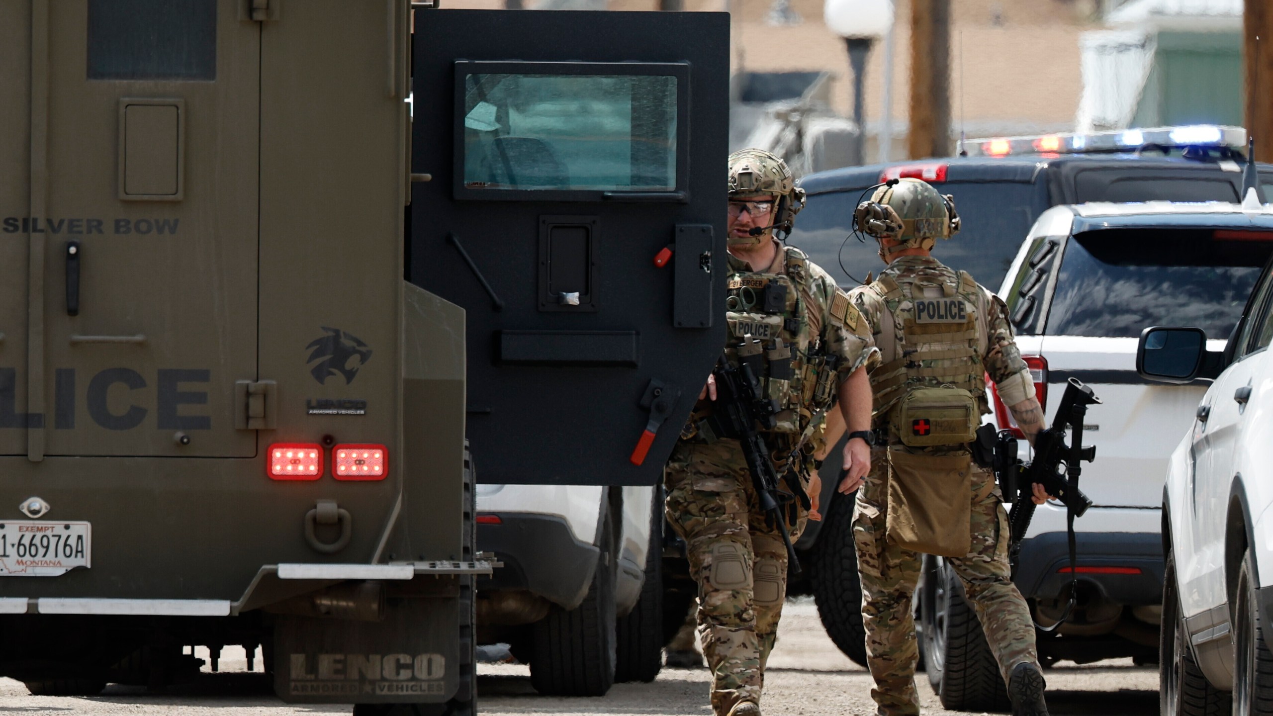 Law enforcement personnel respond to a reported shooting in Anaconda, Mont., Friday, Aug. 1, 2025. (Joseph Scheller/The Montana Standard via AP)