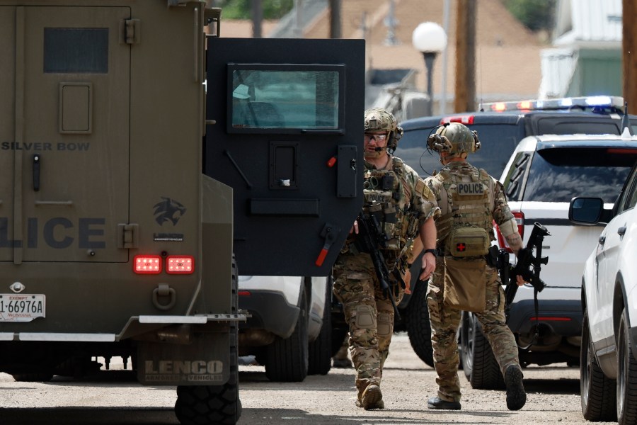Law enforcement personnel respond to a reported shooting in Anaconda, Mont., Friday, Aug. 1, 2025. (Joseph Scheller/The Montana Standard via AP)