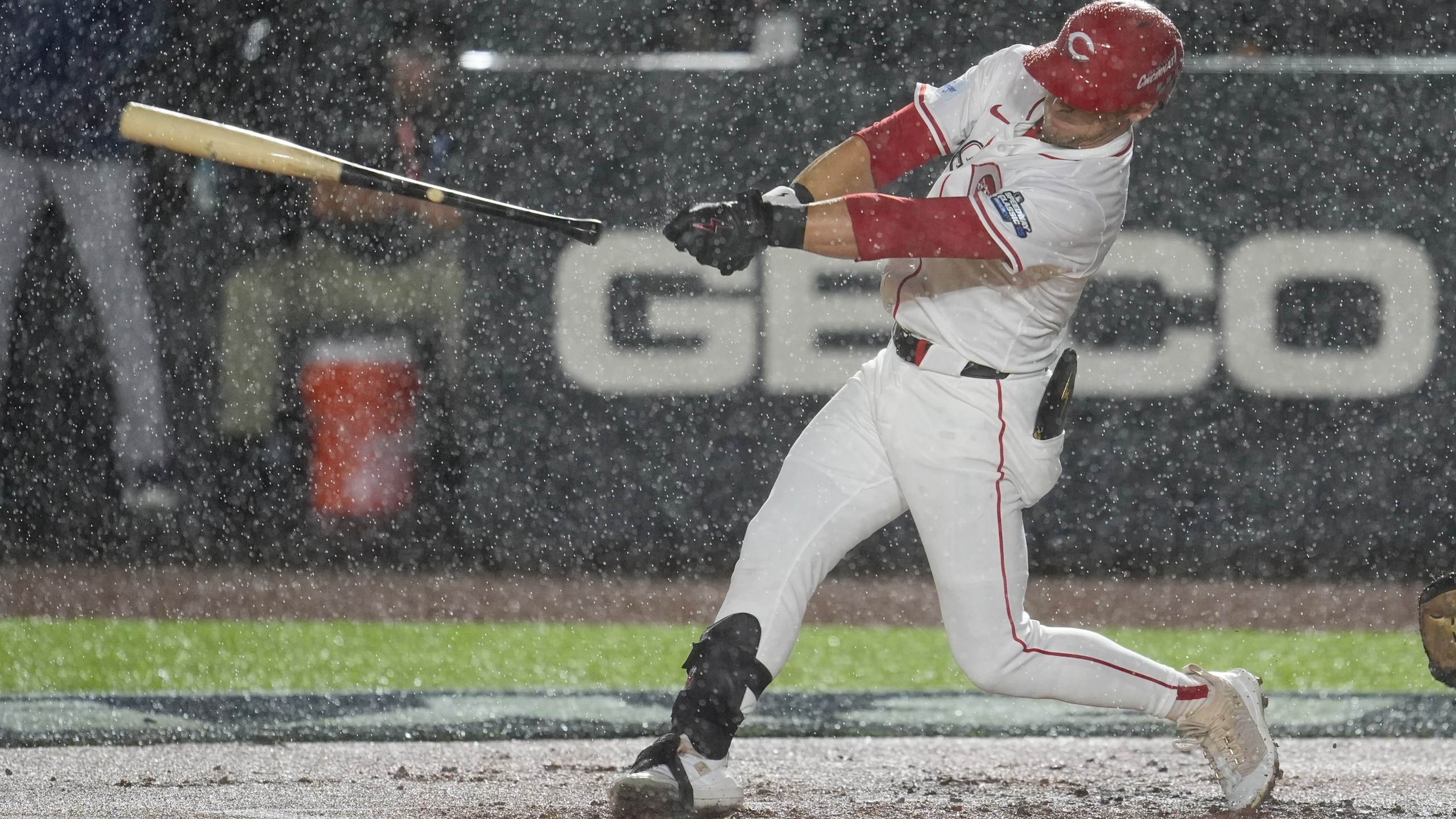 Cincinnati Reds TJ Friedl lets go of the bat in the rain during the first inning of the MLB Speedway Classic baseball game between the Atlanta Braves and the Cincinnati Reds at Bristol Motor Speedway in Bristol, Tenn., Saturday, Aug. 2, 2025. (AP Photo/George Walker IV)