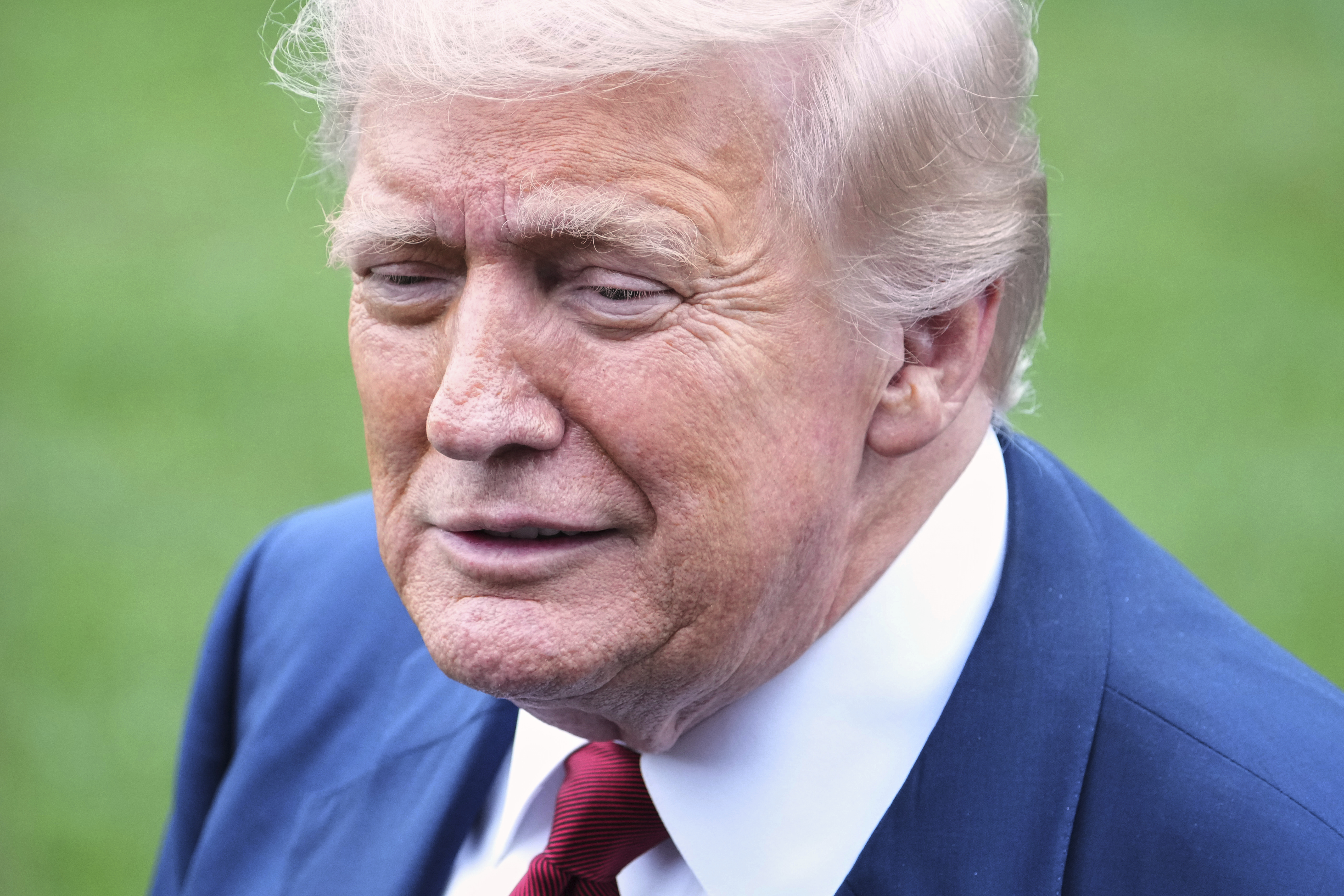 President Donald Trump speaks with reporters before walking across the South Lawn of the White House to board Marine One en route to Joint Base Andrews, Md., Friday, Aug. 1, 2025, in Washington. (AP Photo/Jacquelyn Martin)