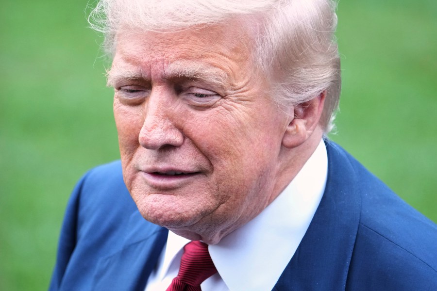 President Donald Trump speaks with reporters before walking across the South Lawn of the White House to board Marine One en route to Joint Base Andrews, Md., Friday, Aug. 1, 2025, in Washington. (AP Photo/Jacquelyn Martin)