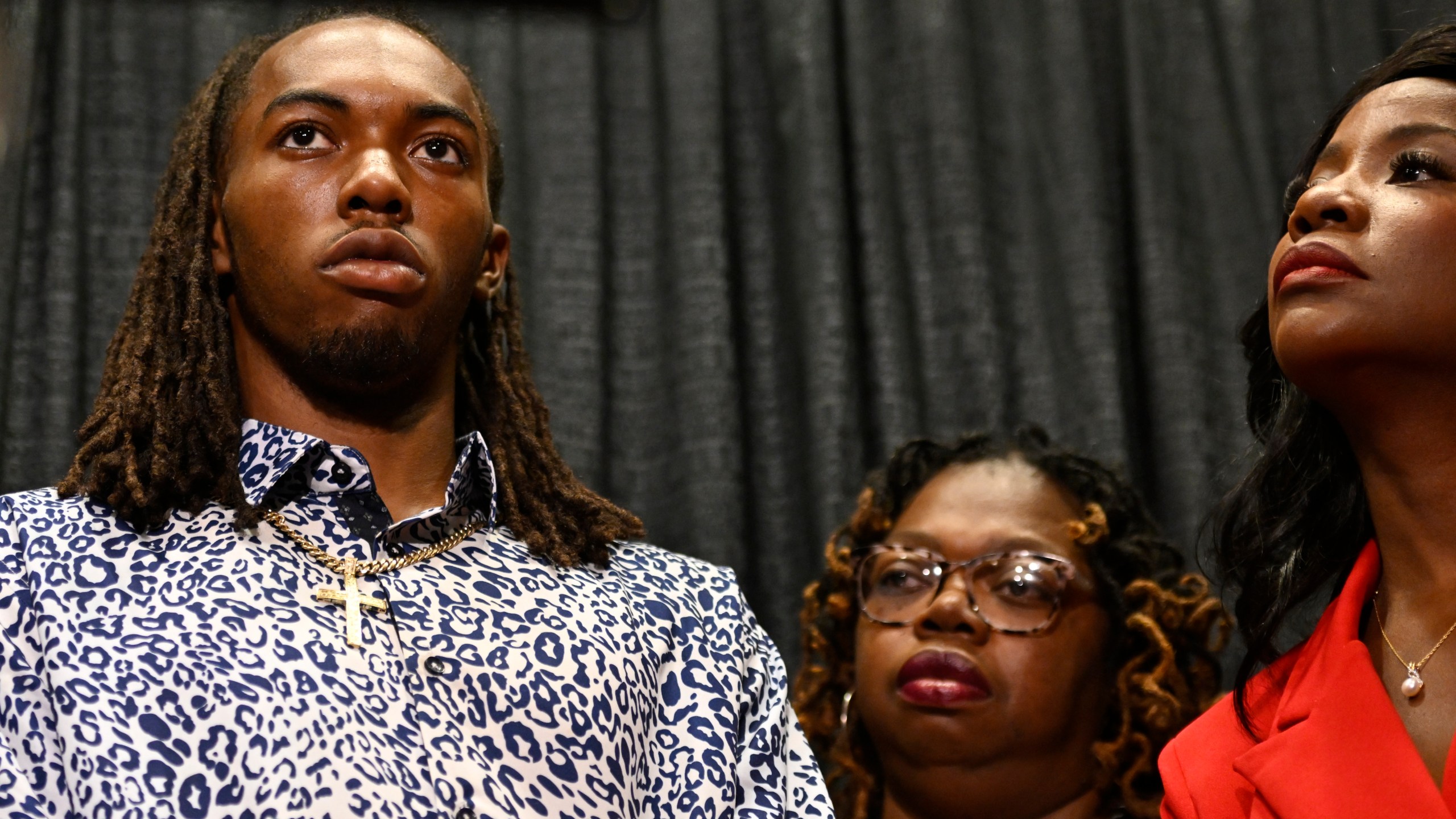 William McNeil Jr., left, along with his mother Latoya Solomon, center, and attorney Sue-Ann Robinson, right, look on during a press conference Tuesday, July 29, 2025, in Chicago. (AP Photo/Paul Beaty)
