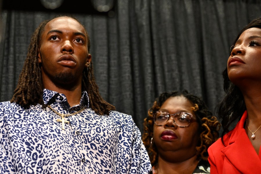 William McNeil Jr., left, along with his mother Latoya Solomon, center, and attorney Sue-Ann Robinson, right, look on during a press conference Tuesday, July 29, 2025, in Chicago. (AP Photo/Paul Beaty)