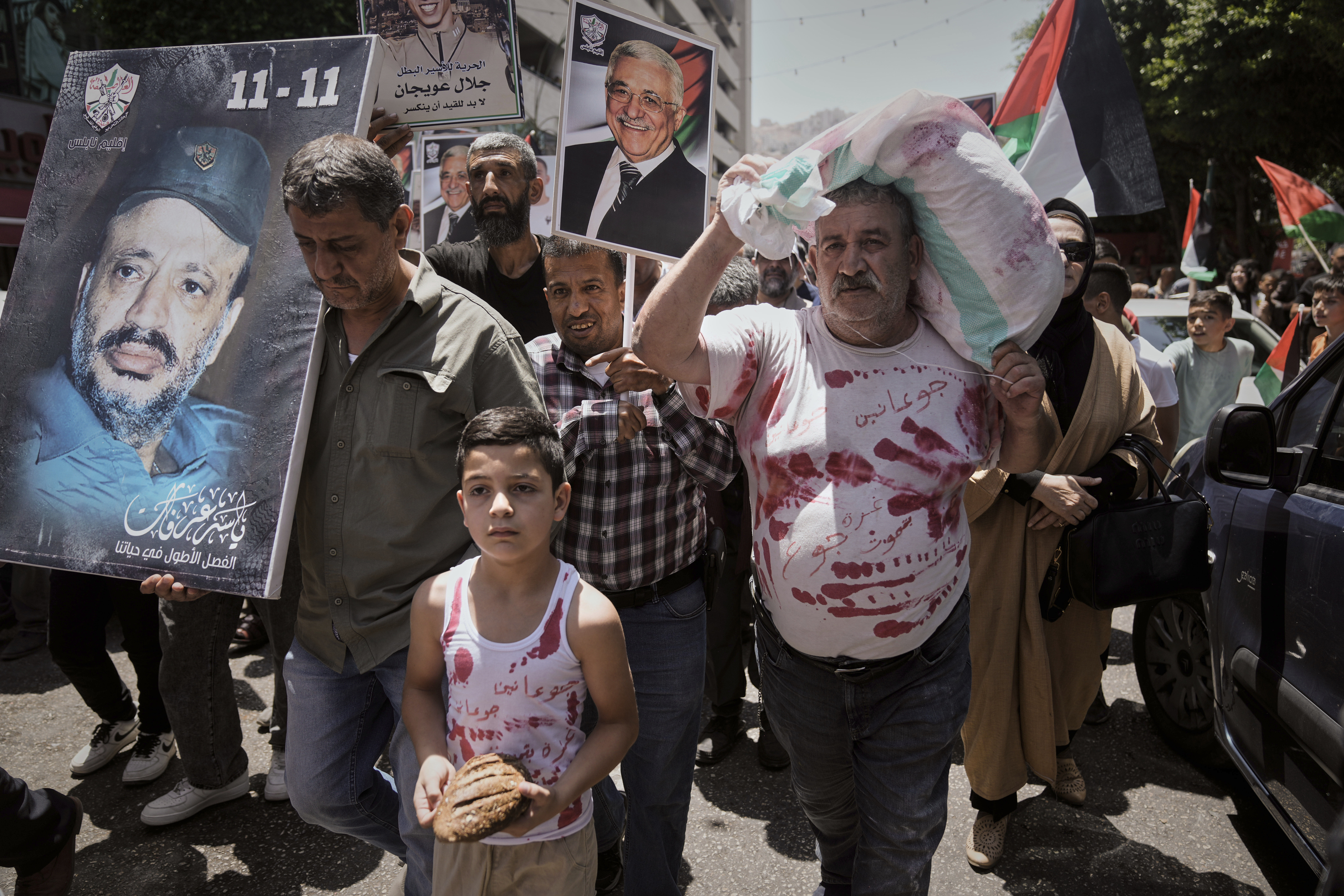 People participate in a demonstration in support of Palestinians in the Gaza Strip amid the ongoing Israel-Hamas war, in Nablus, West Bank, Sunday, Aug. 3, 2025. (AP Photo/Majdi Mohammed)