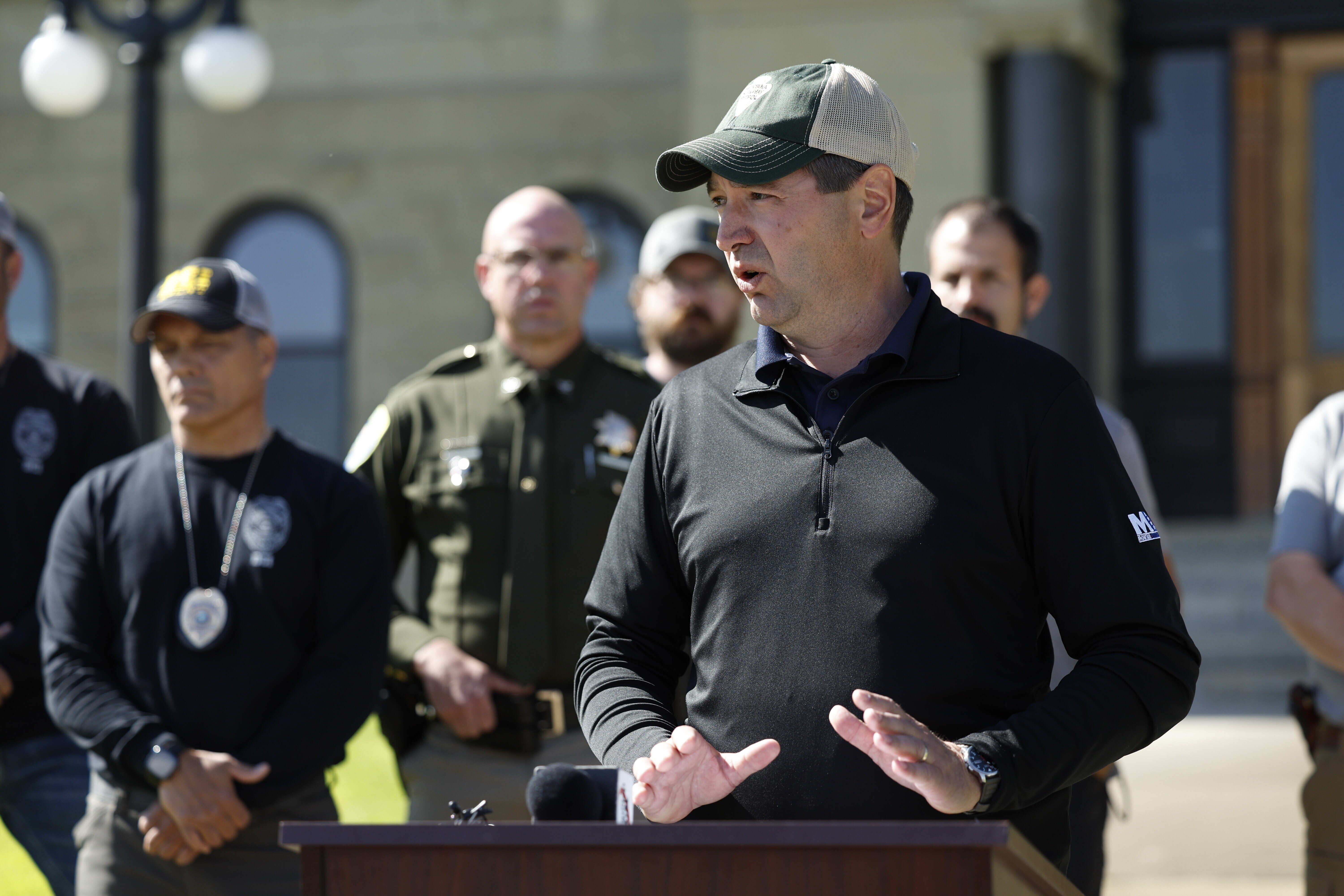 Montana Attorney General Austin Knudsen speaks to the media Sunday, Aug. 3, 2025 in front of the Anaconda-Deer Lodge County Courthouse in Anaconda, Mont., about the ongoing search for shooting suspect Michael Brown. (Joseph Scheller/The Montana Standard via AP)