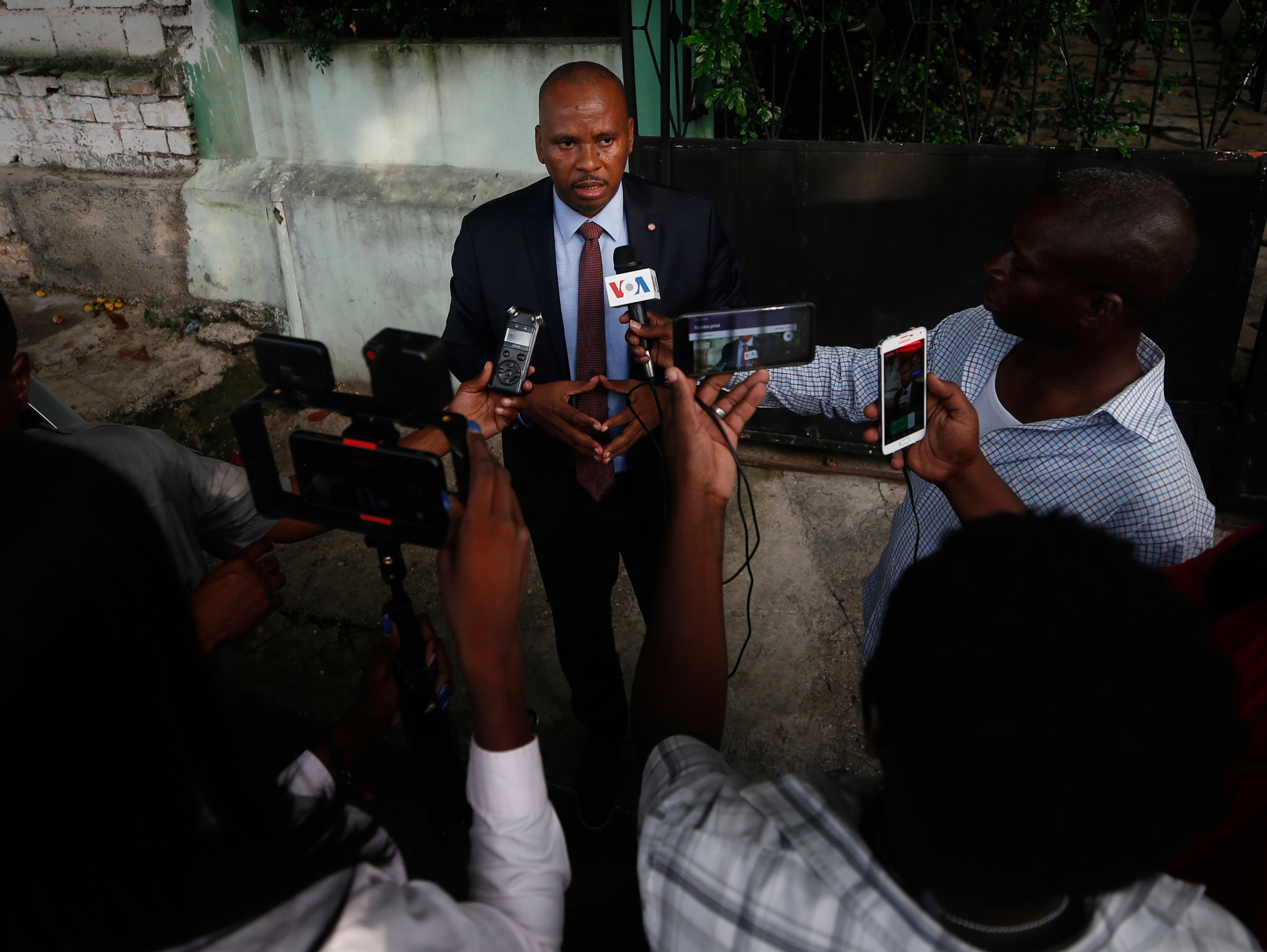 FILE - Senator Nenel Cassy speaks to journalists after a news conference in Port-au-Prince, Haiti, Oct. 3, 2019. (AP Photo/Rebecca Blackwell, file)