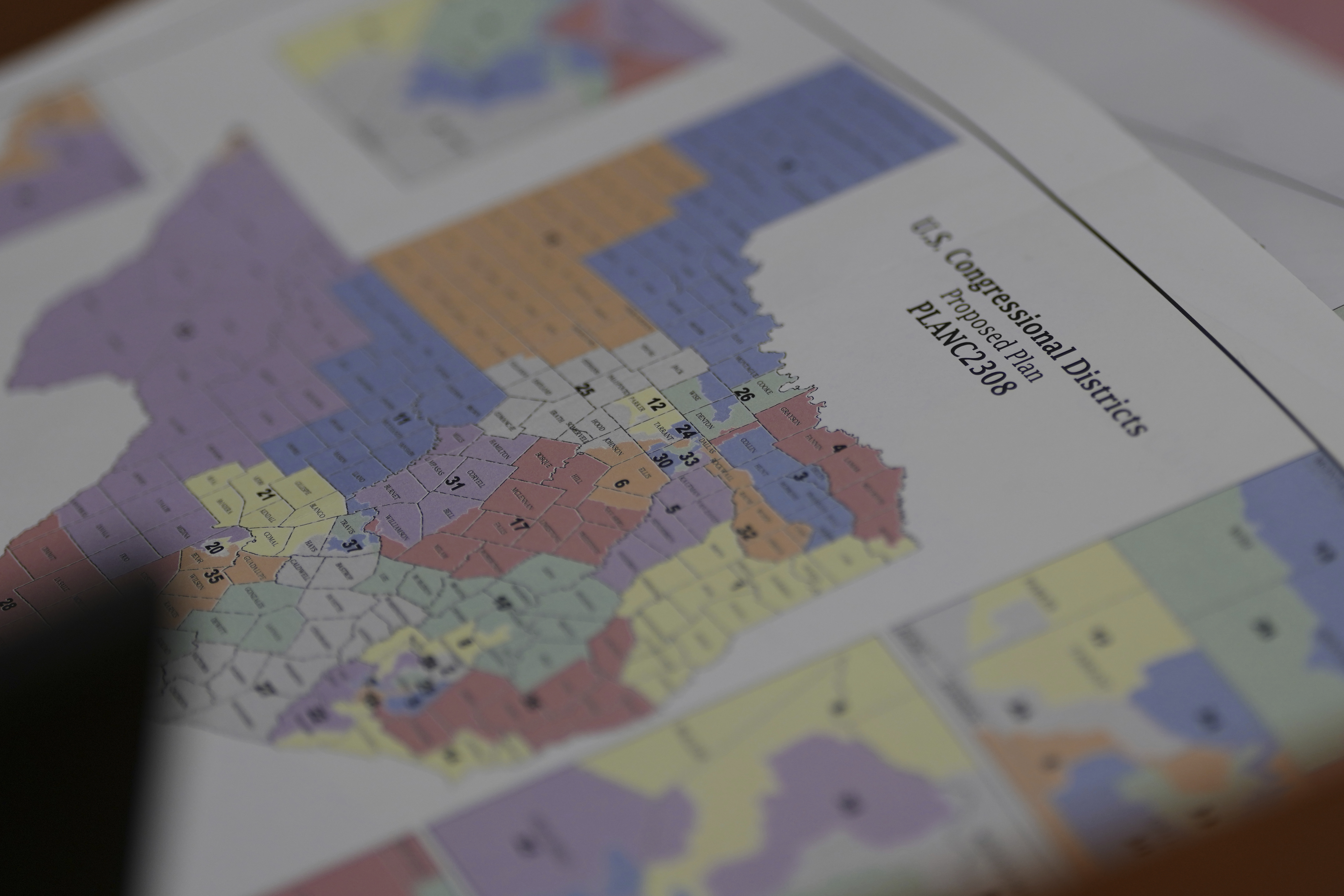 A map of U.S Congressional Districts proposed Plan is seen a Texas legislators' public hearing on congressional redistricting in Austin, Texas, Friday, Aug. 1, 2025. (AP Photo/Eric Gay)