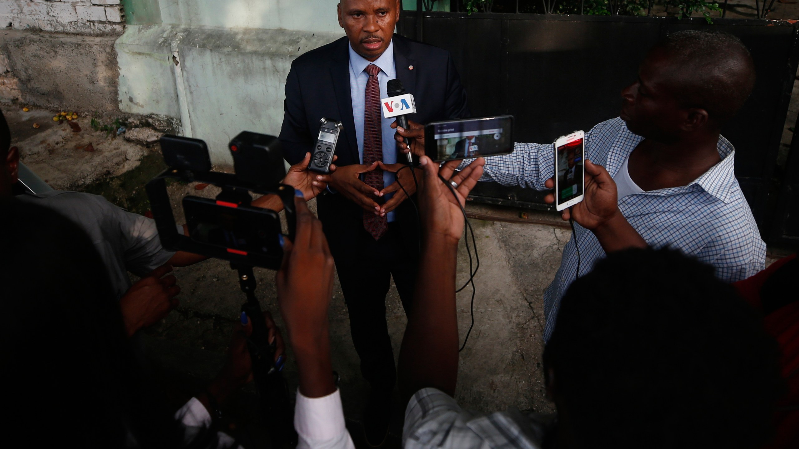 FILE - Senator Nenel Cassy speaks to journalists after a news conference in Port-au-Prince, Haiti, Oct. 3, 2019. (AP Photo/Rebecca Blackwell, file)