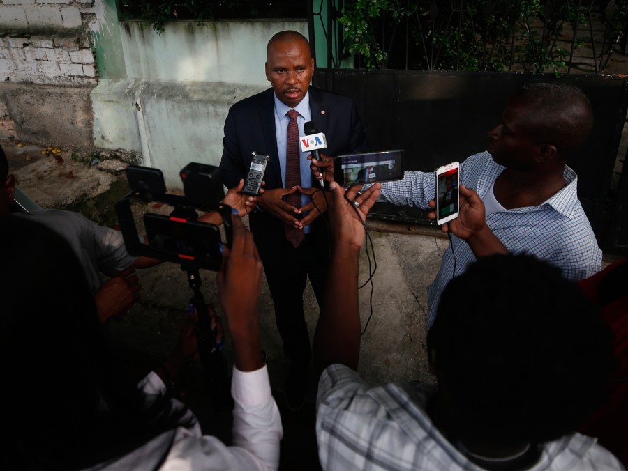 FILE - Senator Nenel Cassy speaks to journalists after a news conference in Port-au-Prince, Haiti, Oct. 3, 2019. (AP Photo/Rebecca Blackwell, file)