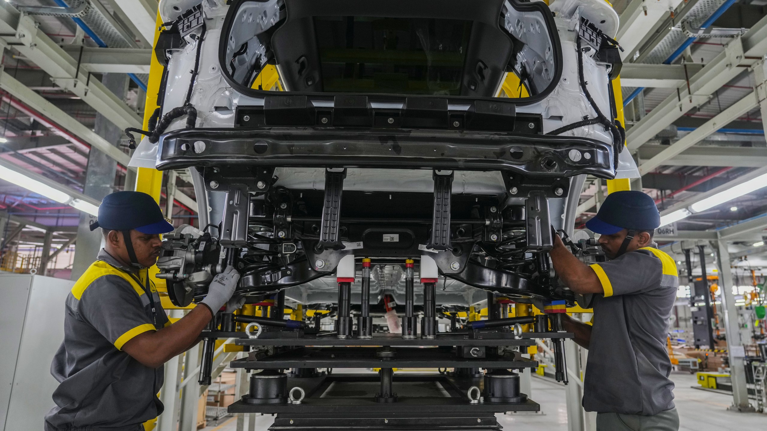 Workers assemble a car at the Vinfast electric vehicle plant in Thoothukudi, in the southern Indian state of Tamil Nadu, Monday, Aug. 4, 2025. (AP Photo/ Rafiq Maqbool)