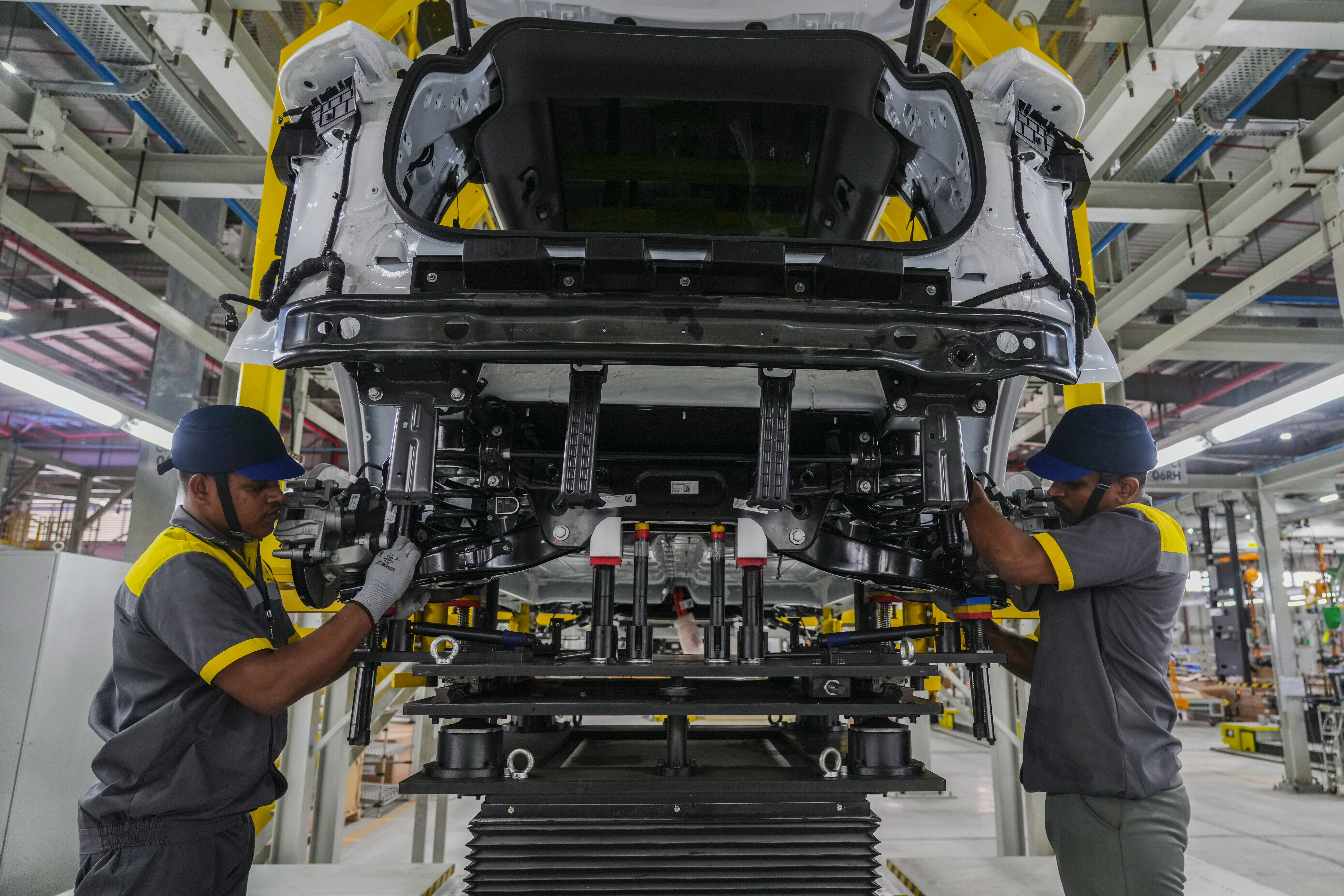 Workers assemble a car at the Vinfast electric vehicle plant in Thoothukudi, in the southern Indian state of Tamil Nadu, Monday, Aug. 4, 2025. (AP Photo/ Rafiq Maqbool)
