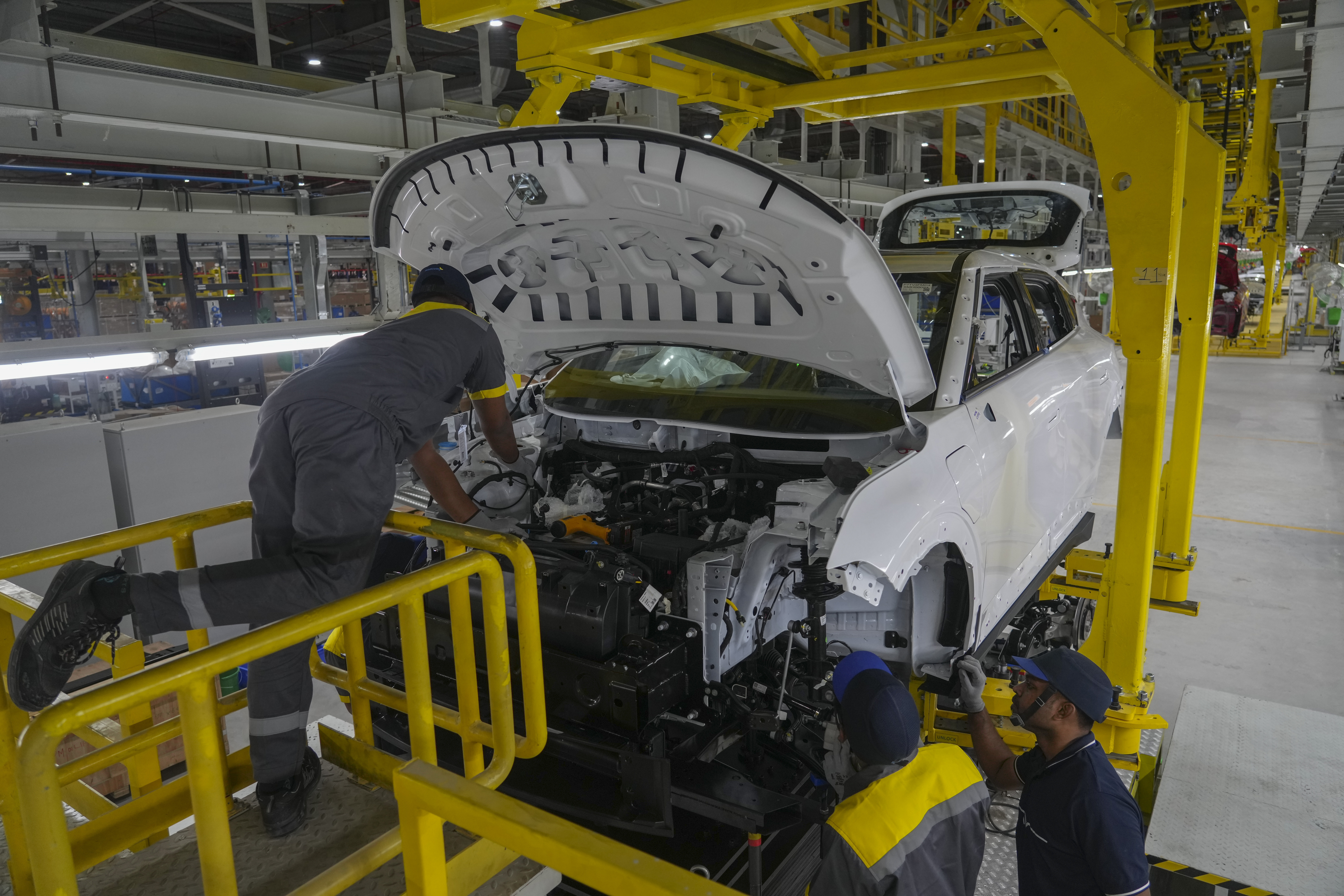 Workers assemble a car at the Vinfast electric vehicle plant in Thoothukudi, in the southern Indian state of Tamil Nadu, Monday, Aug. 4, 2025. (AP Photo/ Rafiq Maqbool)