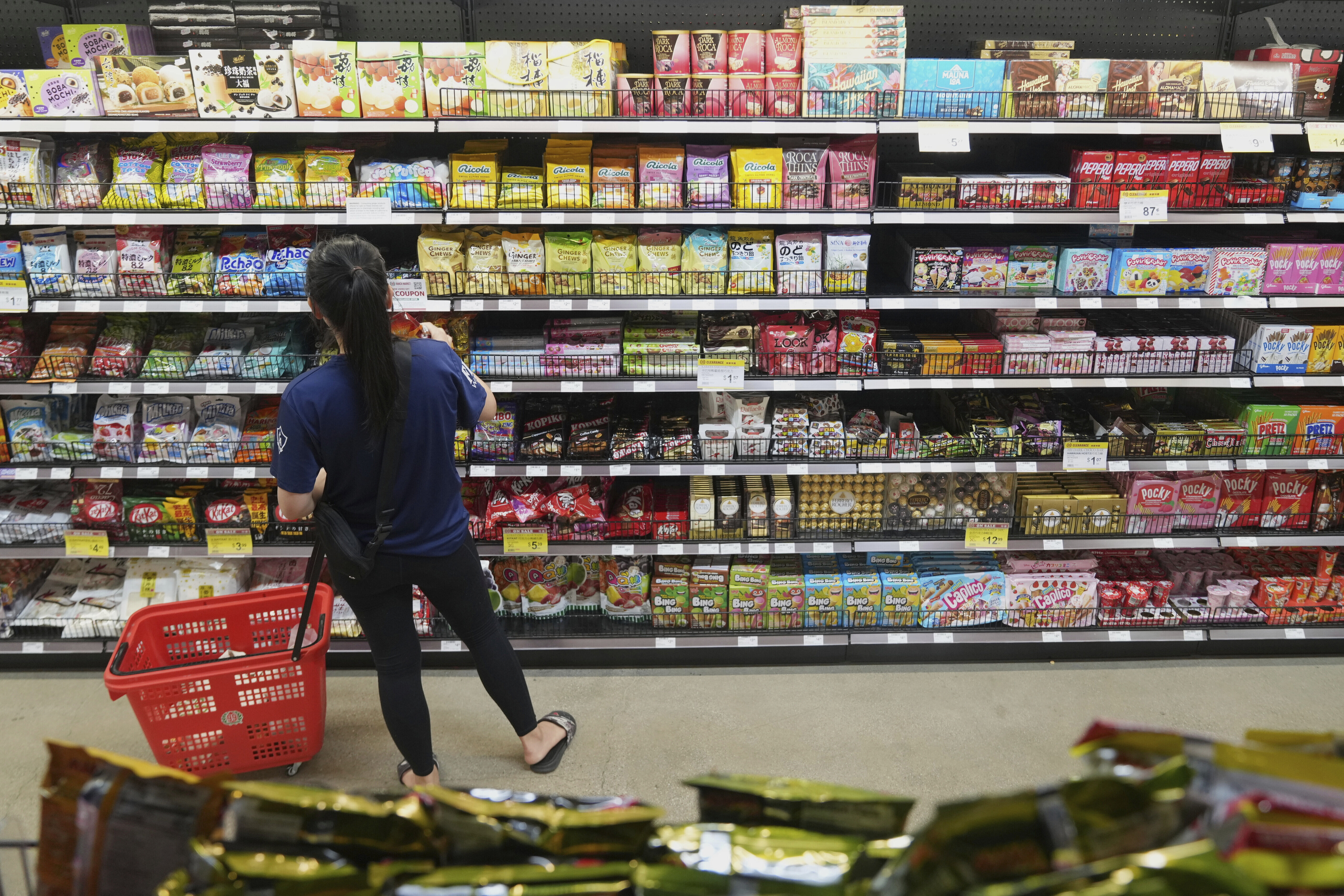 FILE - A customer buys Chinese made ginger candy at 99 Ranch Market, an Asian grocery store in Los Angeles, April 7, 2025. (AP Photo/Damian Dovarganes, File)