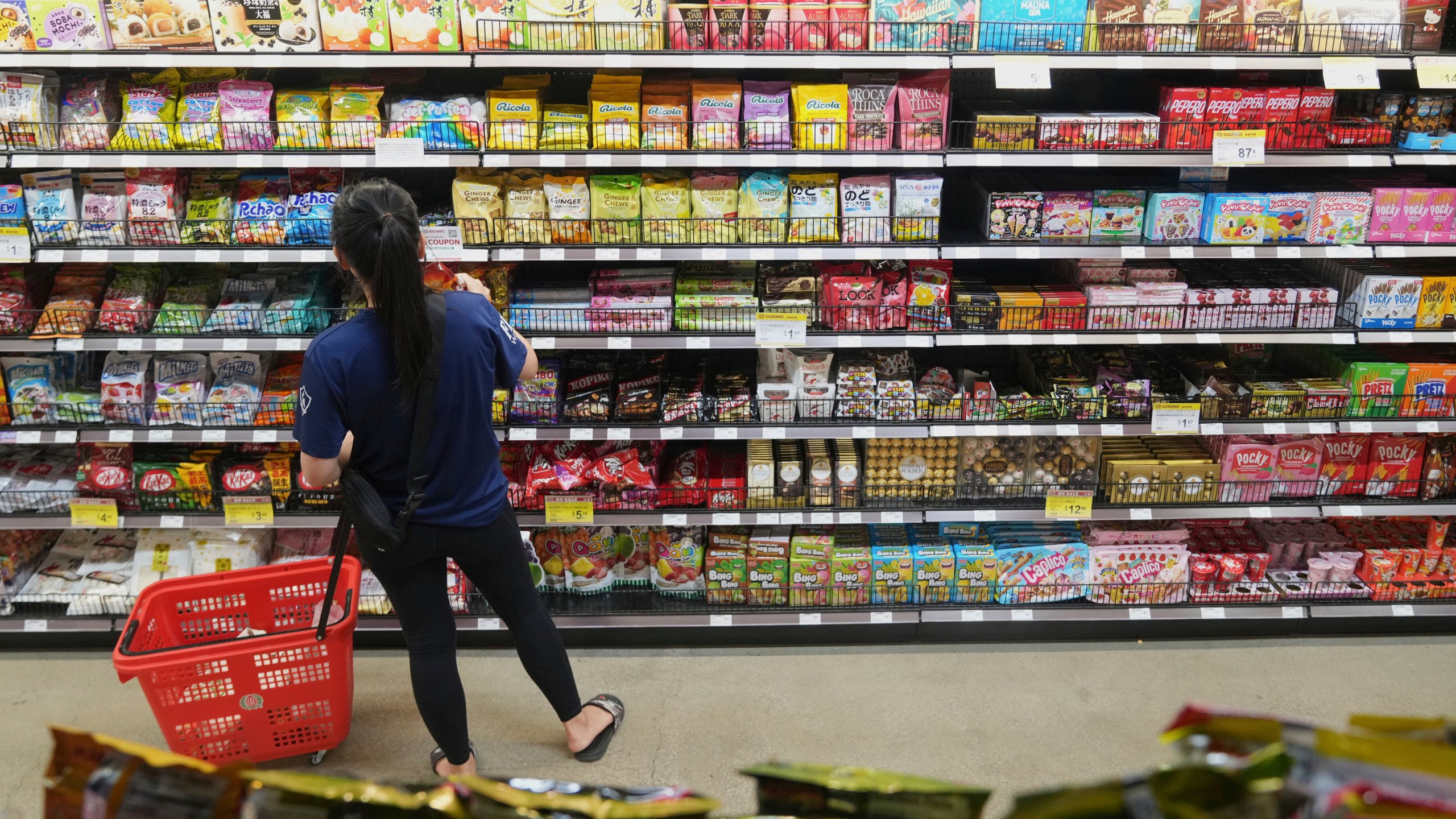 FILE - A customer buys Chinese made ginger candy at 99 Ranch Market, an Asian grocery store in Los Angeles, April 7, 2025. (AP Photo/Damian Dovarganes, File)
